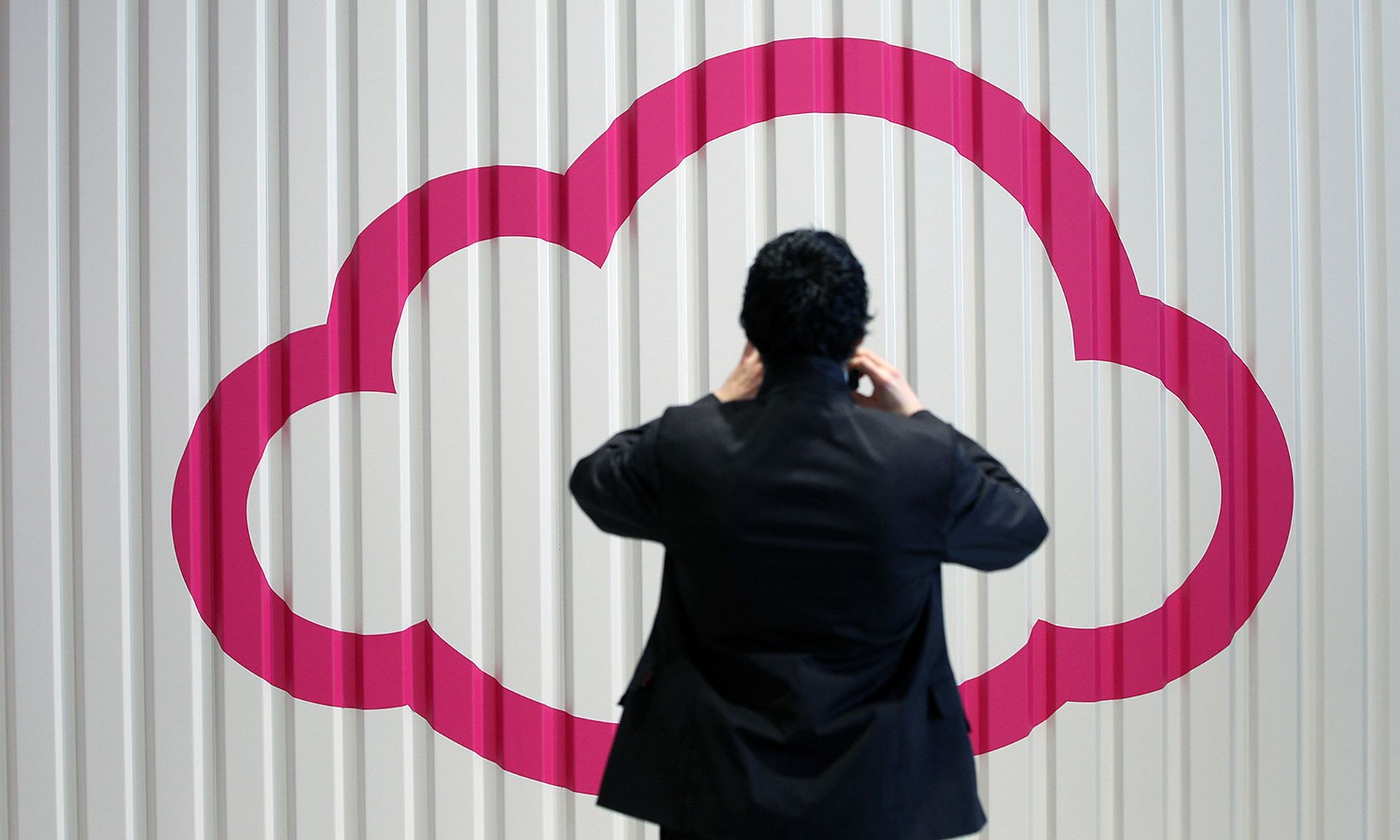 Swimlane raised $70 million in a growth funding round aimed at expanding its security automation products. Pictured: A visitor photographs a symbol of a cloud at the CeBIT 2012 technology trade fair on March 5, 2012, in Hanover, Germany. (Photo by Sean Gallup/Getty Images)