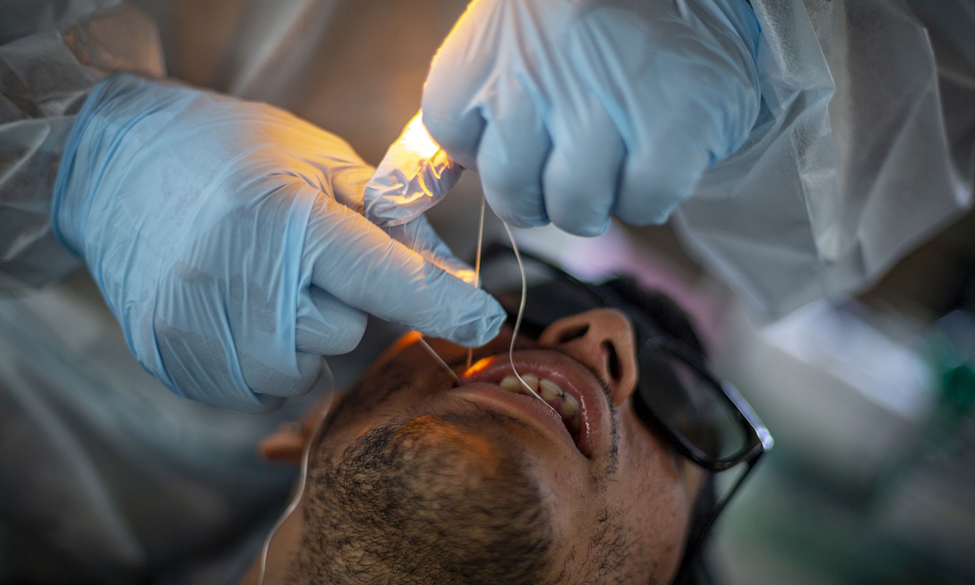 A dental patient receives a flossing.