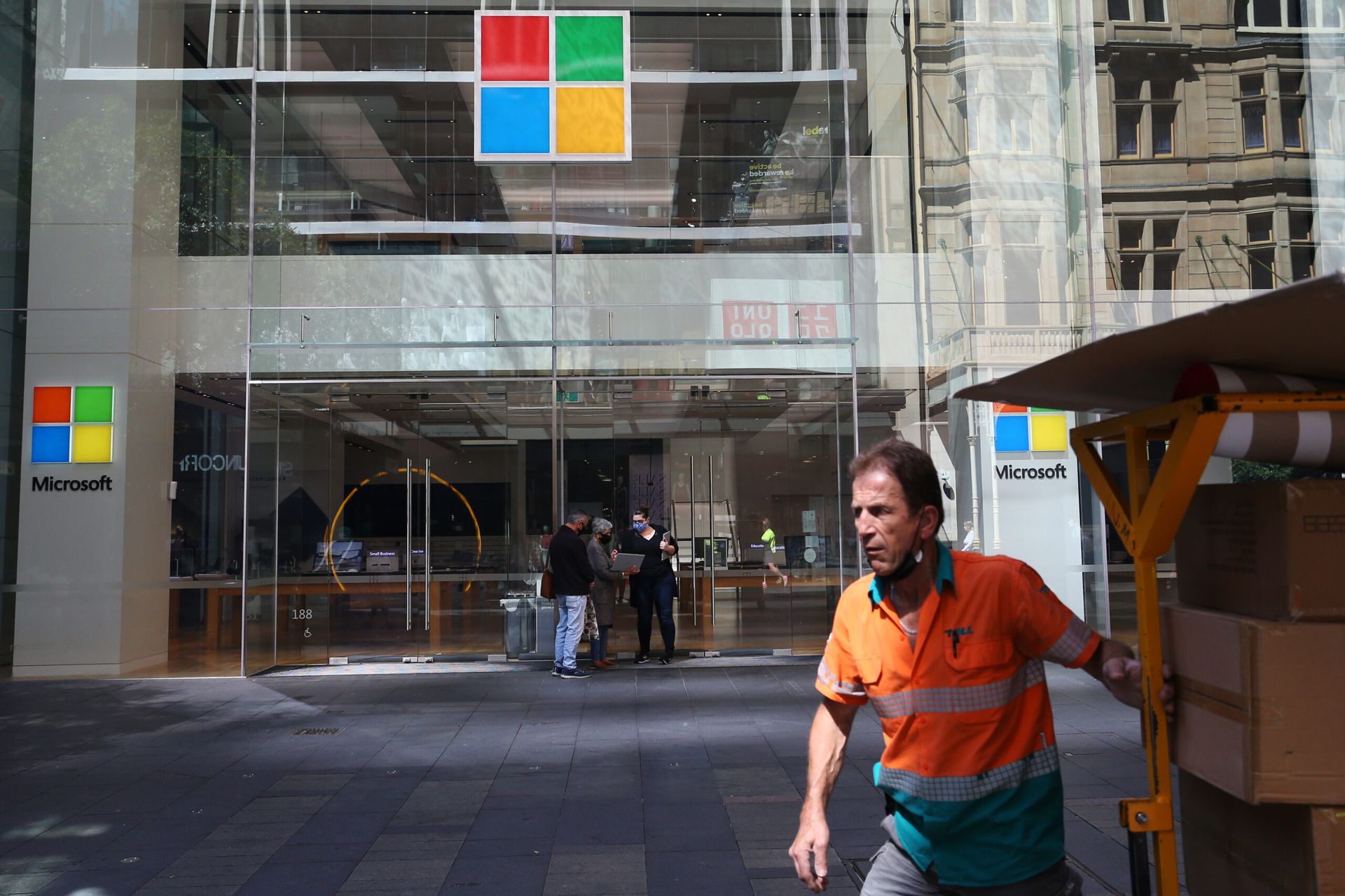 SYDNEY, AUSTRALIA &#8211; OCTOBER 19: People move past a Microsoft store in the Pitt Street shopping district on October 19, 2021 in Sydney, Australia. COVID-19 restrictions have eased further for fully vaccinated people across NSW this week after the state passed its 80 per cent double vaccination target. (Photo by Lisa Maree Williams/Getty Images...