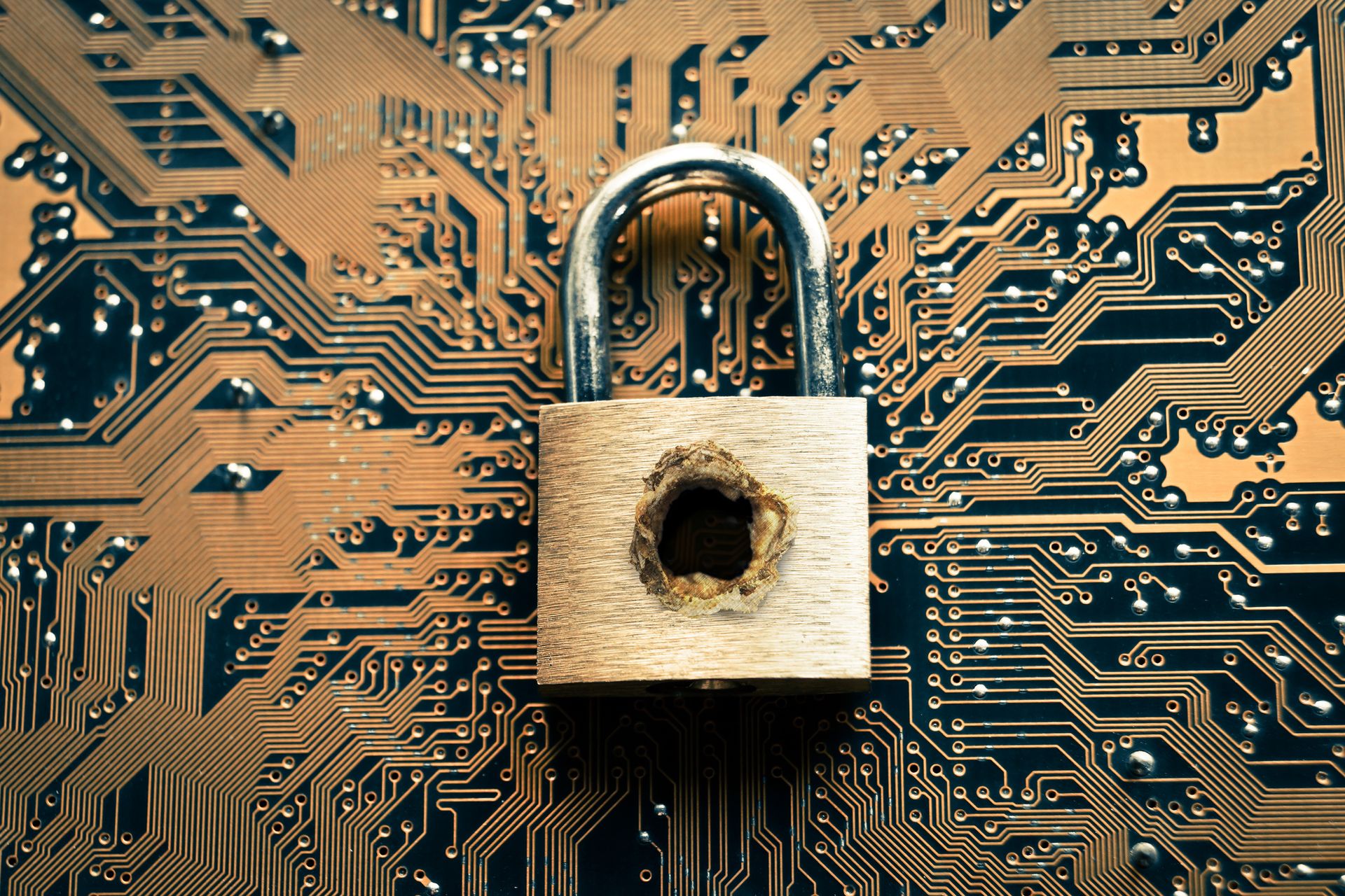 A penetrated security lock with a hole on computer circuit board background