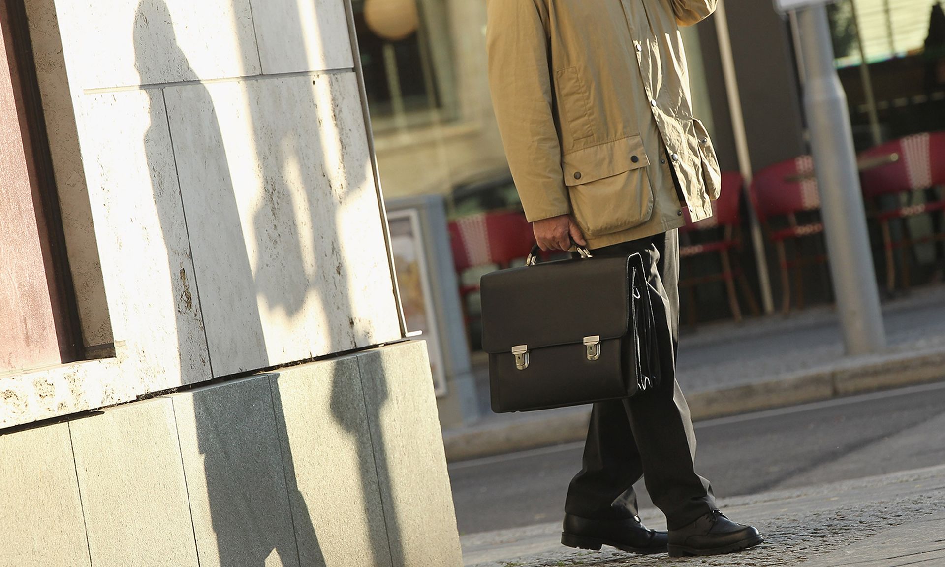 A man carries a briefcase.