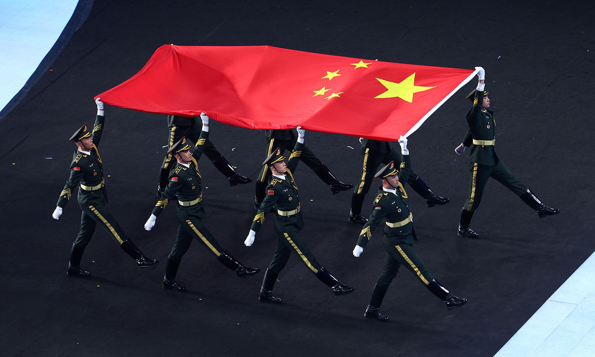 Soldiers carry the Chinese flag