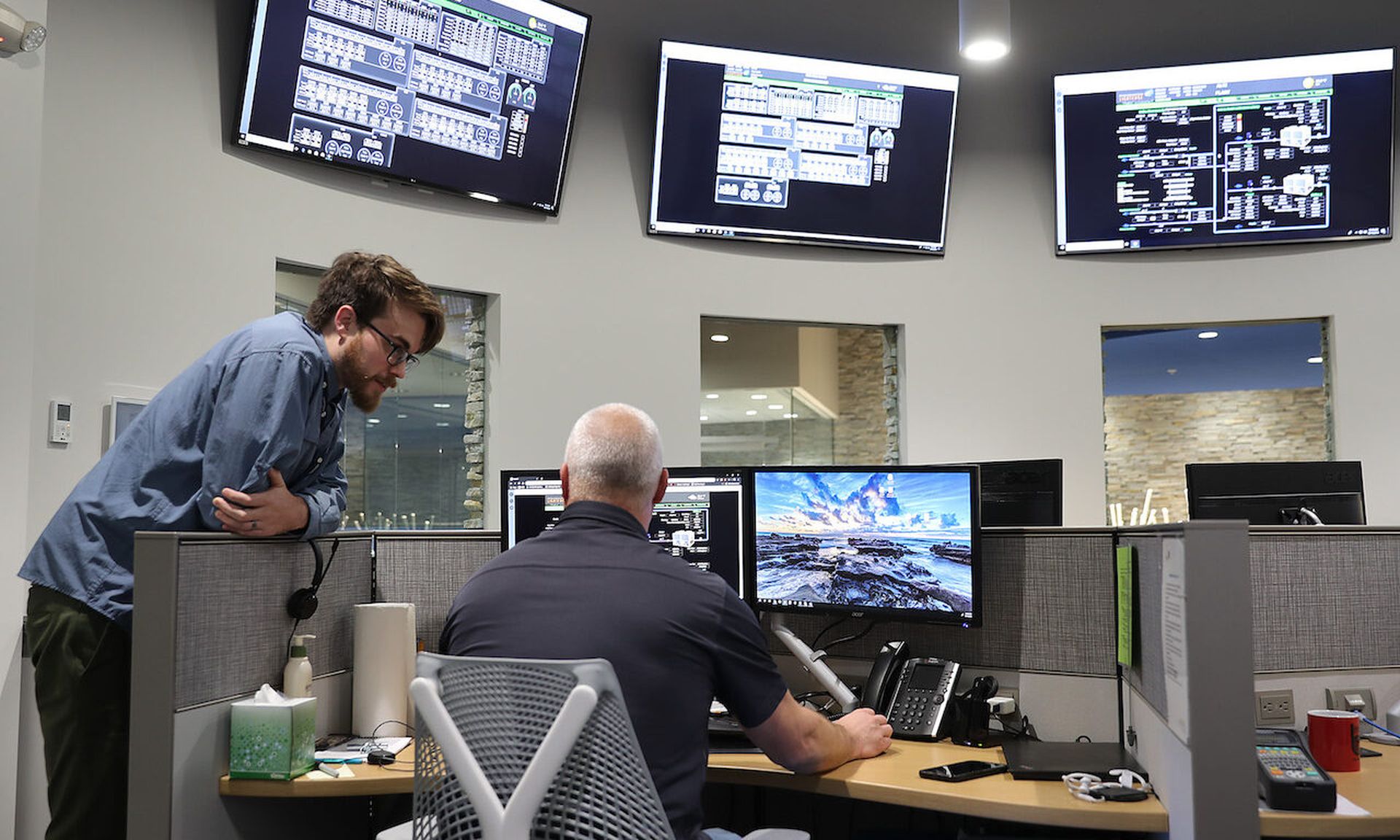 Individuals work at a network operations center at the LightEdge Solutions company on October 15, 2019 in Altoona, Iowa. A new tool from Palo Alto released a tool to help analysts working in security operations center focus on high priority efforts. (Photo by Joe Raedle/Getty Images)