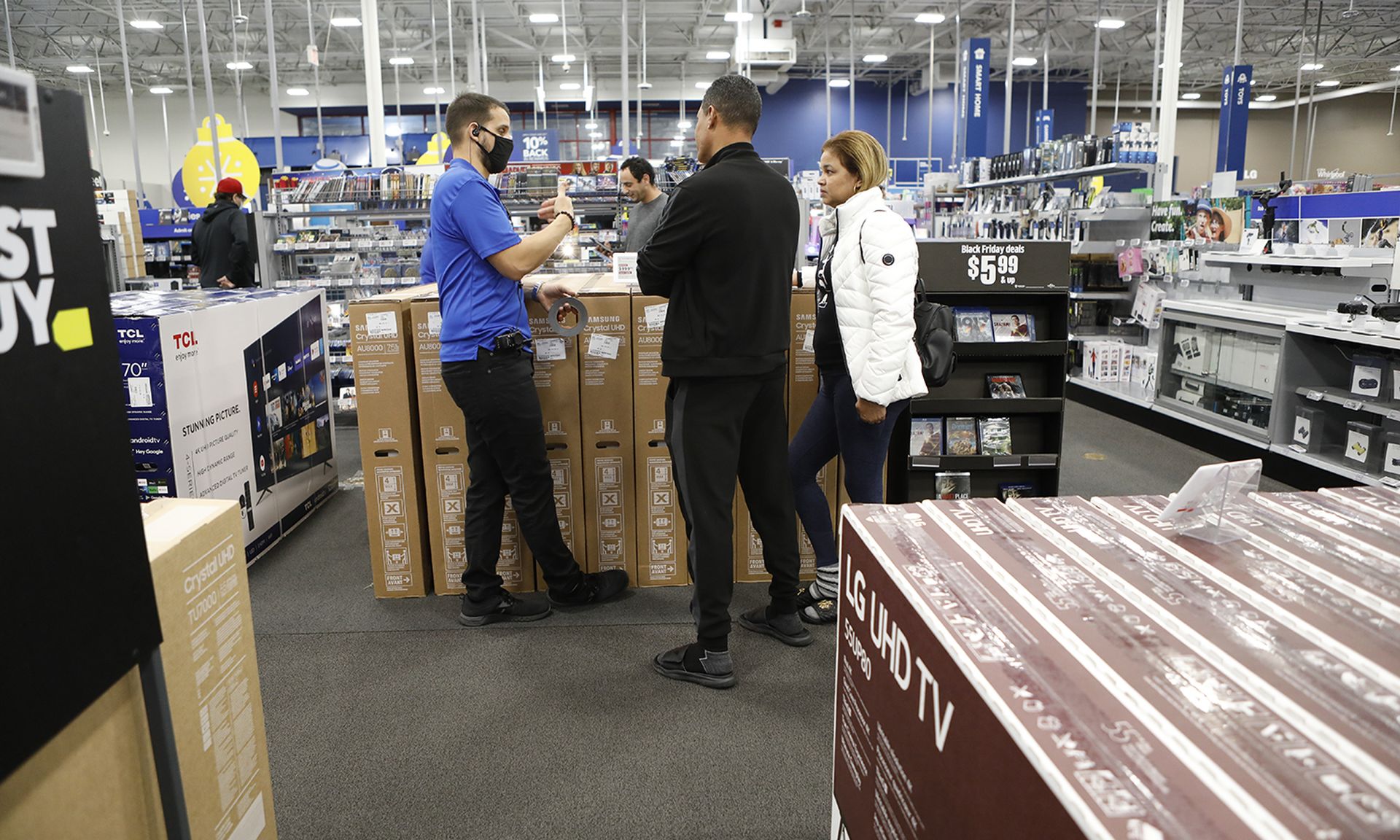 Shoppers look for deals on large screen televisions at a store