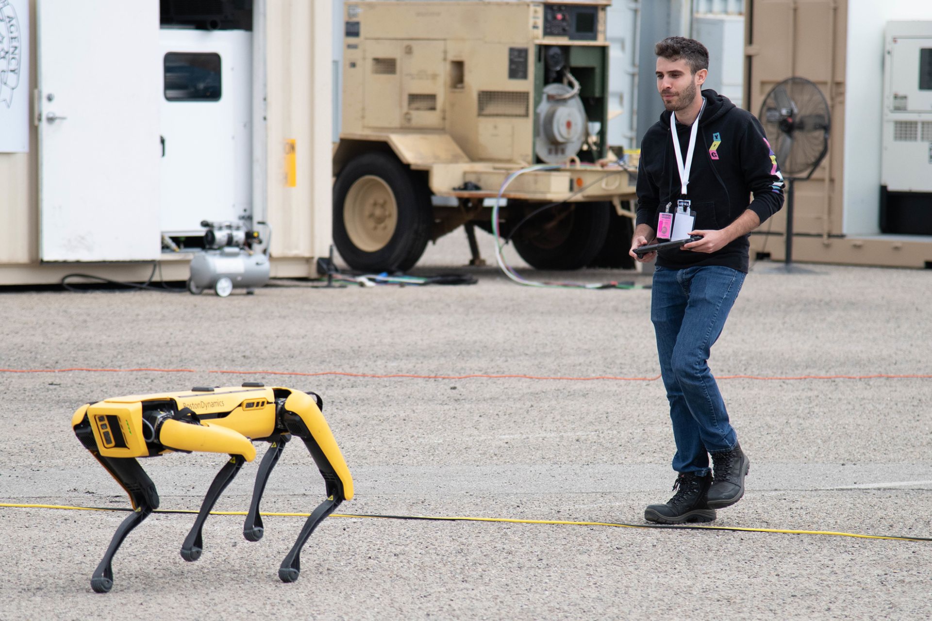 A Naval Surface Warfare Center mechanical engineer controls a Boston Dynamics Spot robot