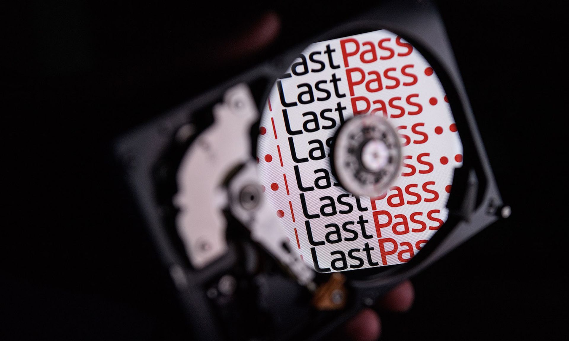 The logo for online password manager service LastPass is reflected on the internal discs of a hard drive.