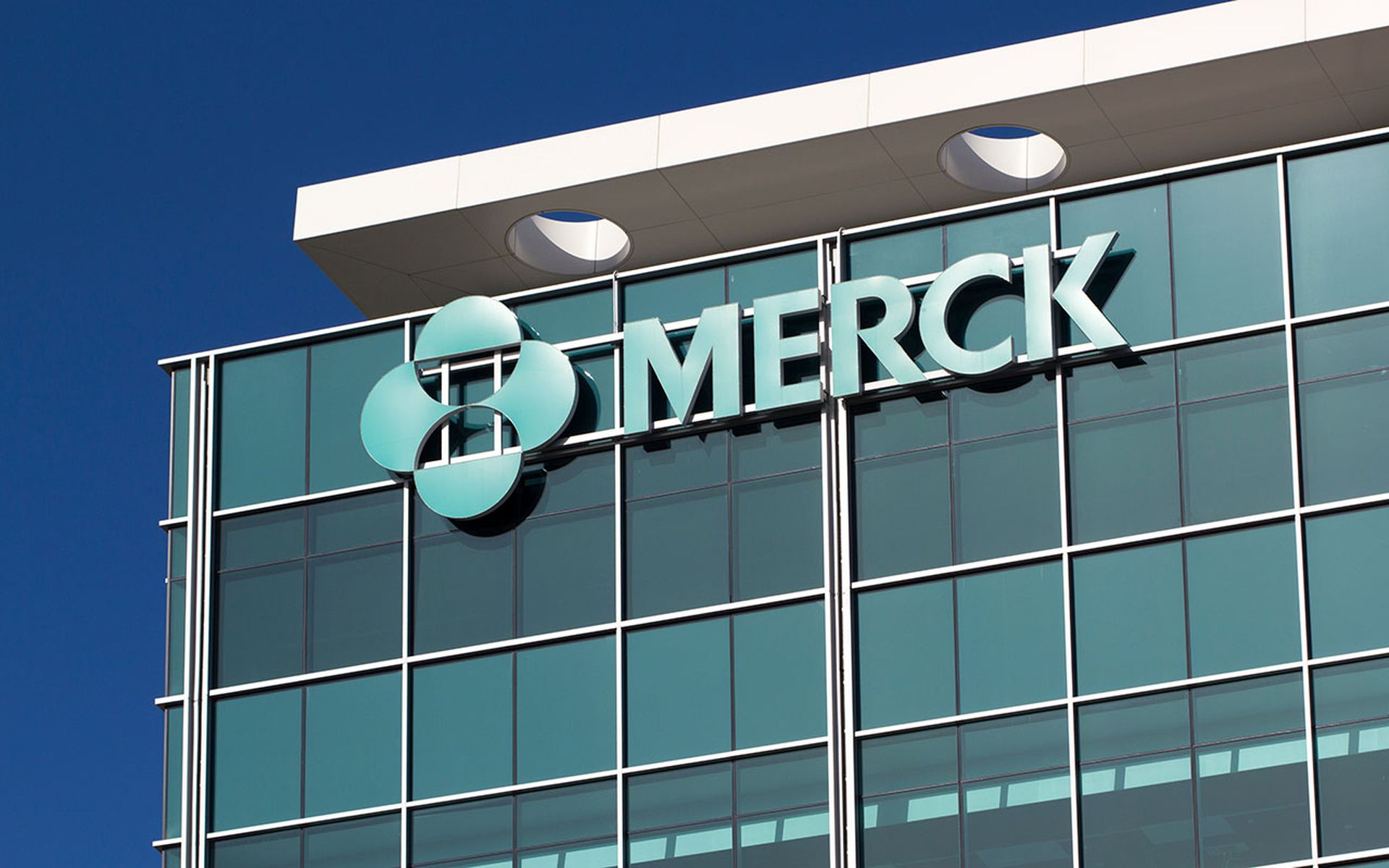 The Merck logo is seen on the side of a building