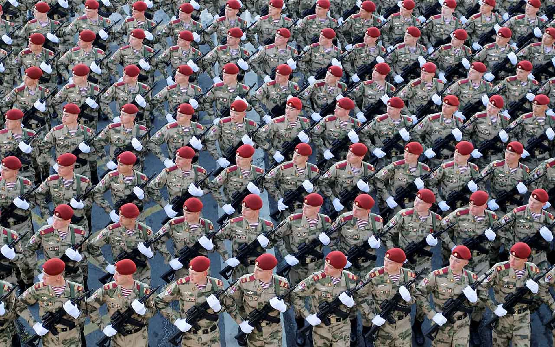 Russian soldiers march in formation during a military parade rehearsal.