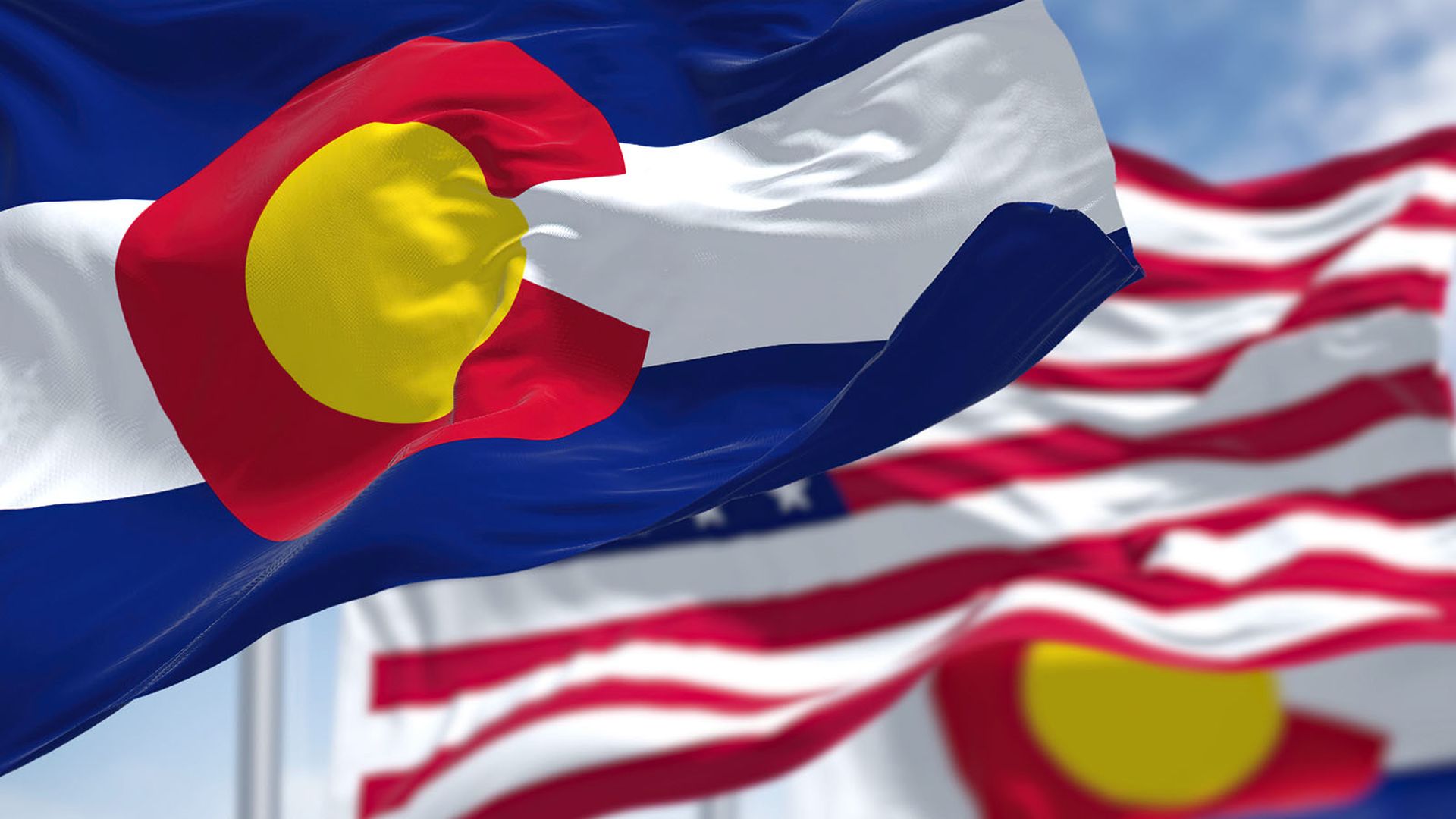 Colorado state flags waving along with the national flag of the United States