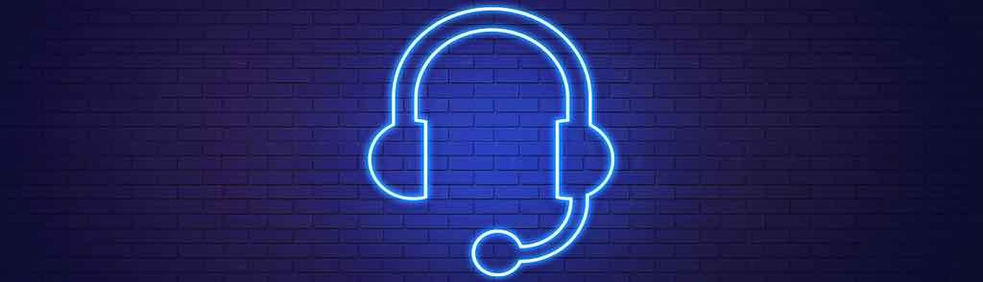 Headset Symbol Drawn by Blue Neon Light on Black Wall