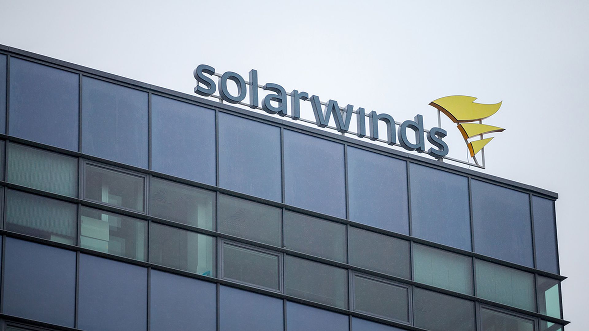 A SolarWinds sign sits on top of an office building.