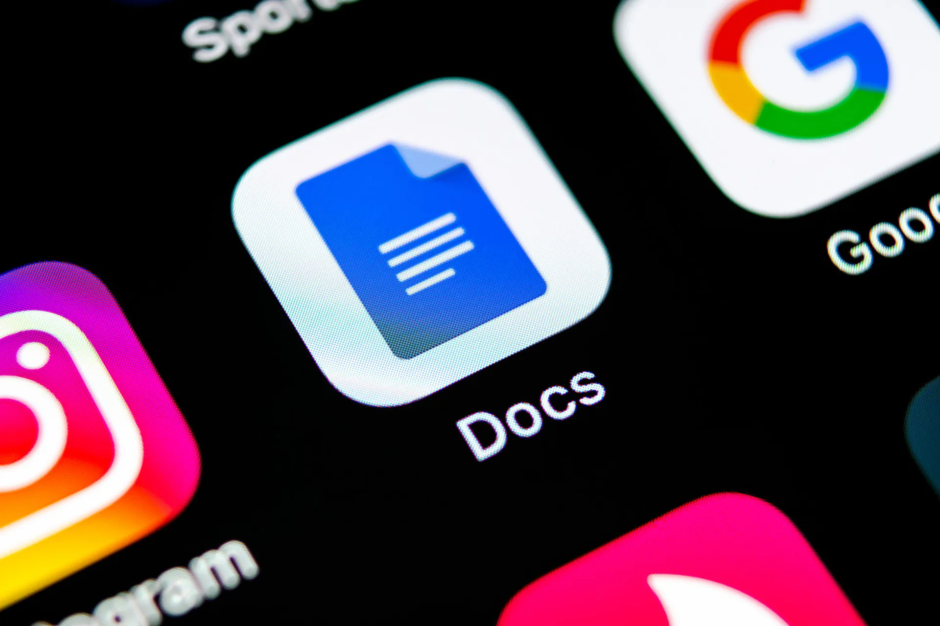 Google Docs icon seen close-up on a smartphone screen.