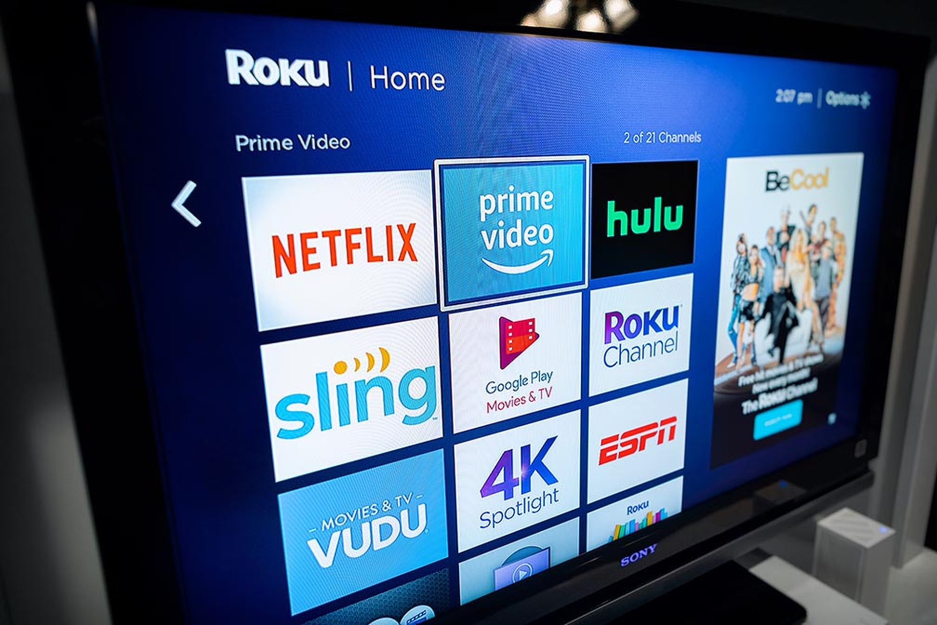 A consumer in a home using a modern smart television to stream various content.