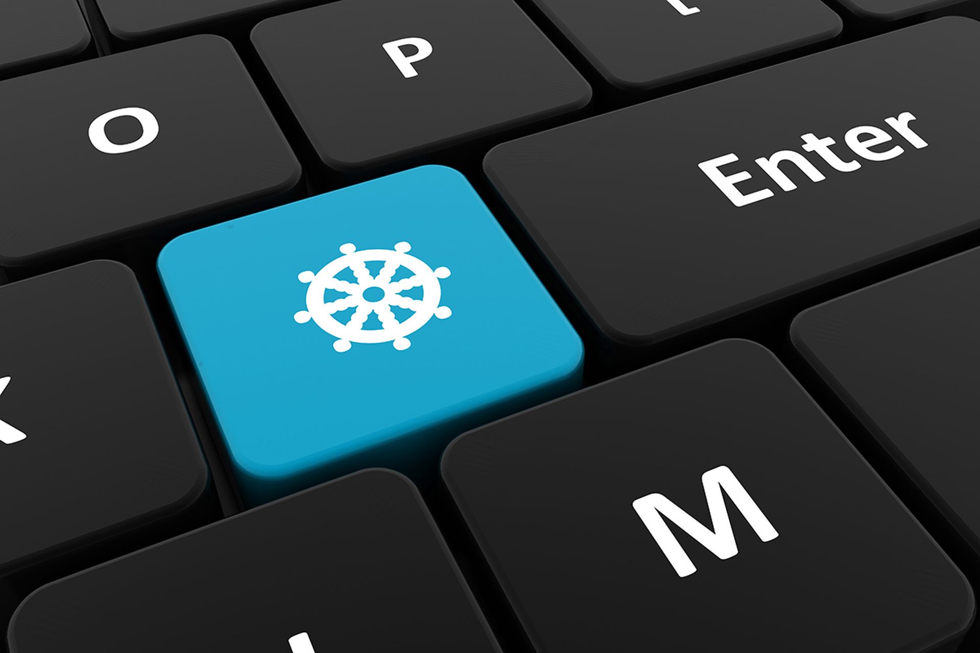 Computer keyboard, close-up button with the image of a ship's steering wheel