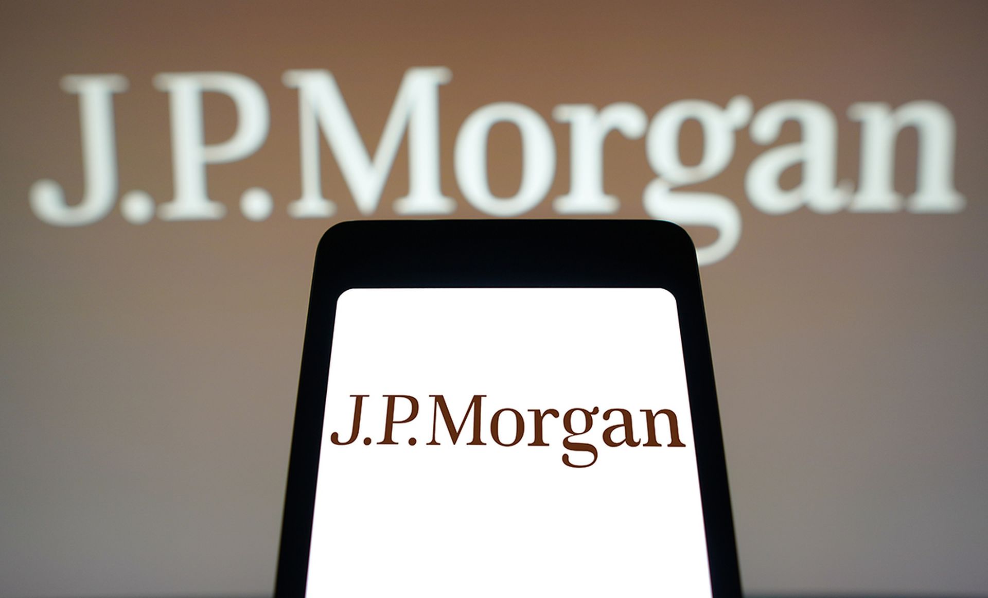 The JPMorgan logo is displayed on a smartphone screen and in the background