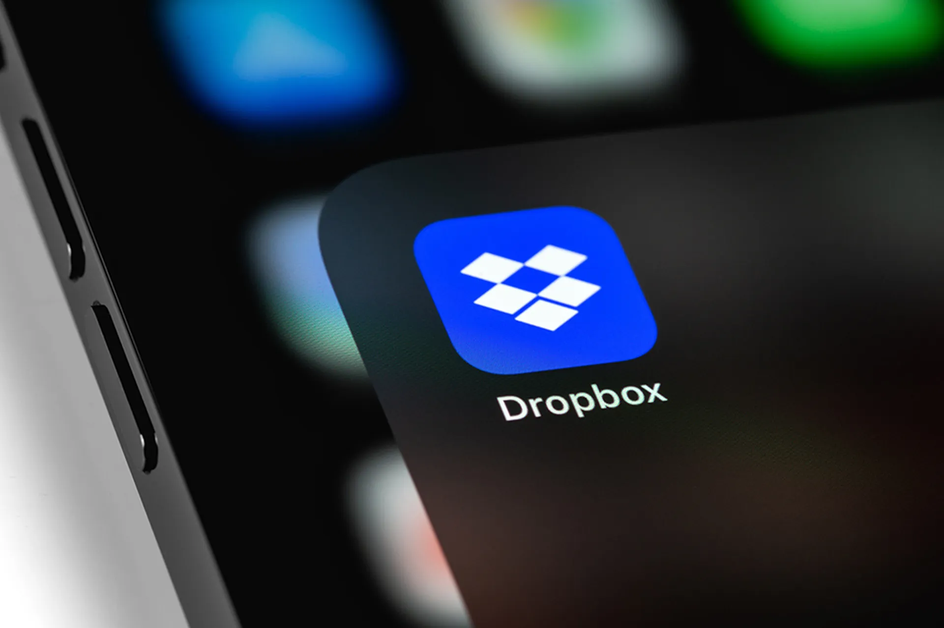 Dropbox mobile icon app on screen smartphone iPhone. Dropbox is file hosting company Dropbox Inc.