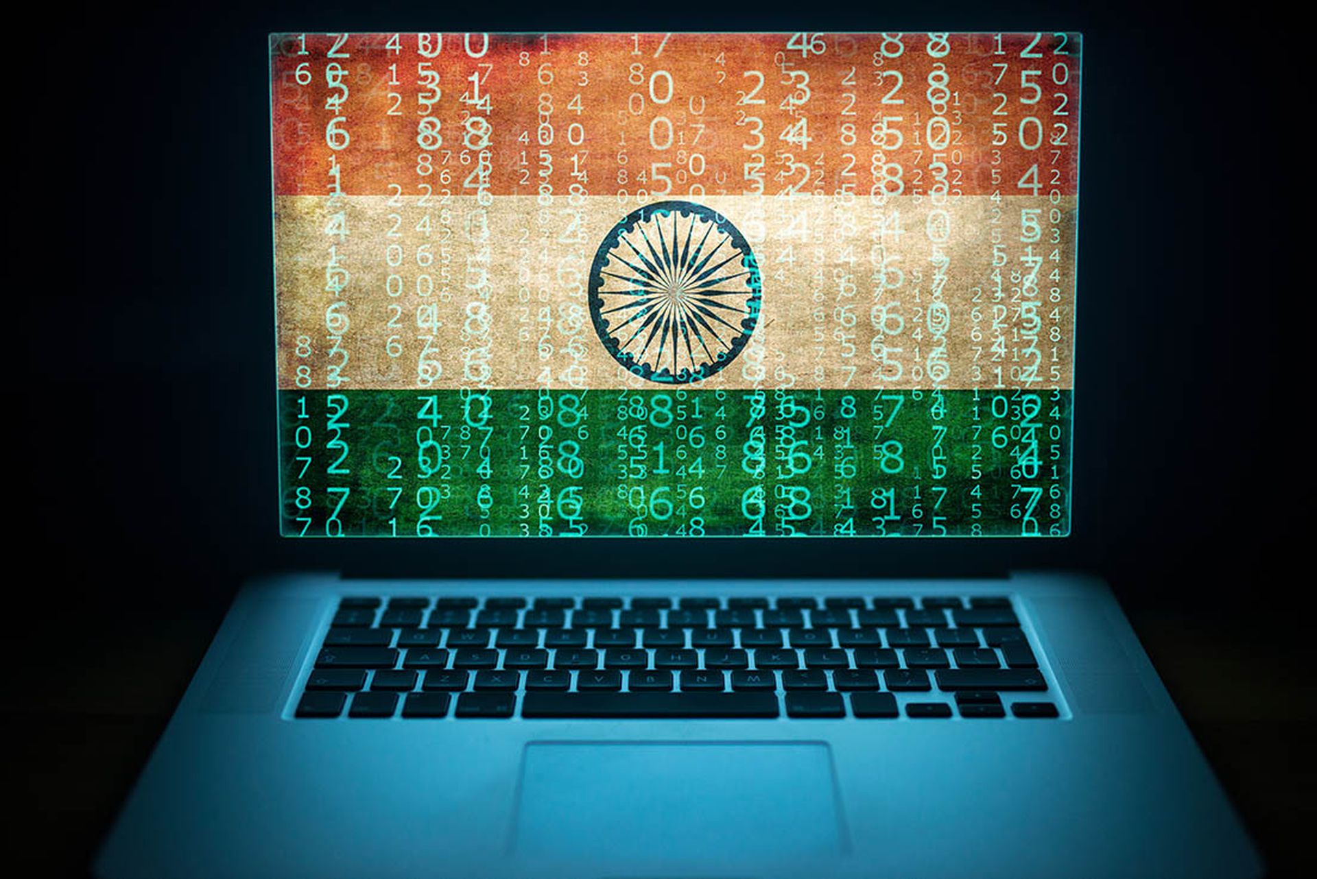 Indian hacker and computer expert. Laptop with binary computer code and India flag on the screen.