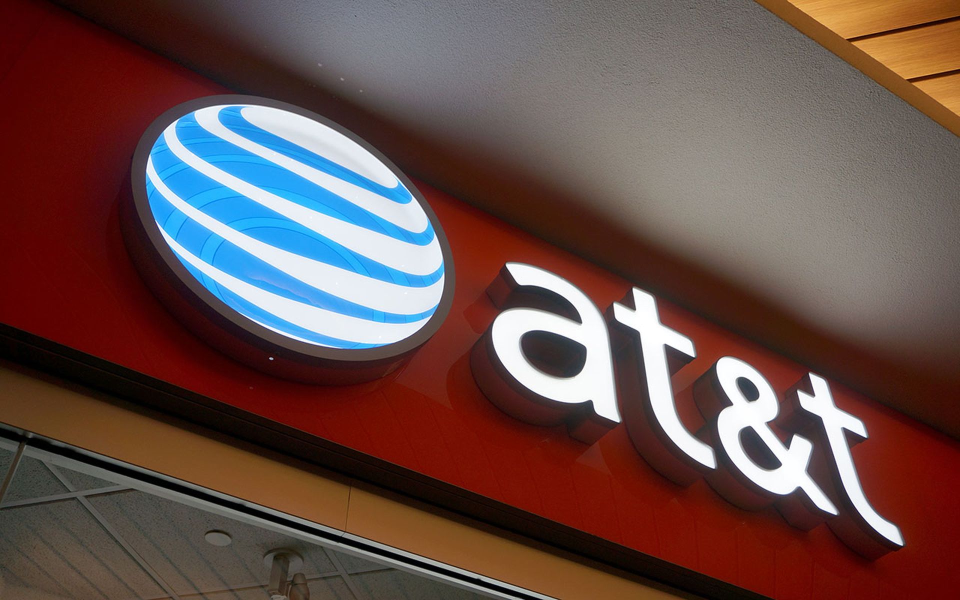 AT&T Logo sign on wall above store in Ala Moana Mall.