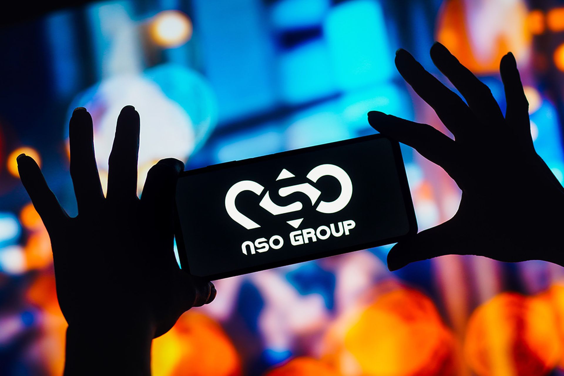 The NSO Group Technologies logo is seen displayed on a smartphone