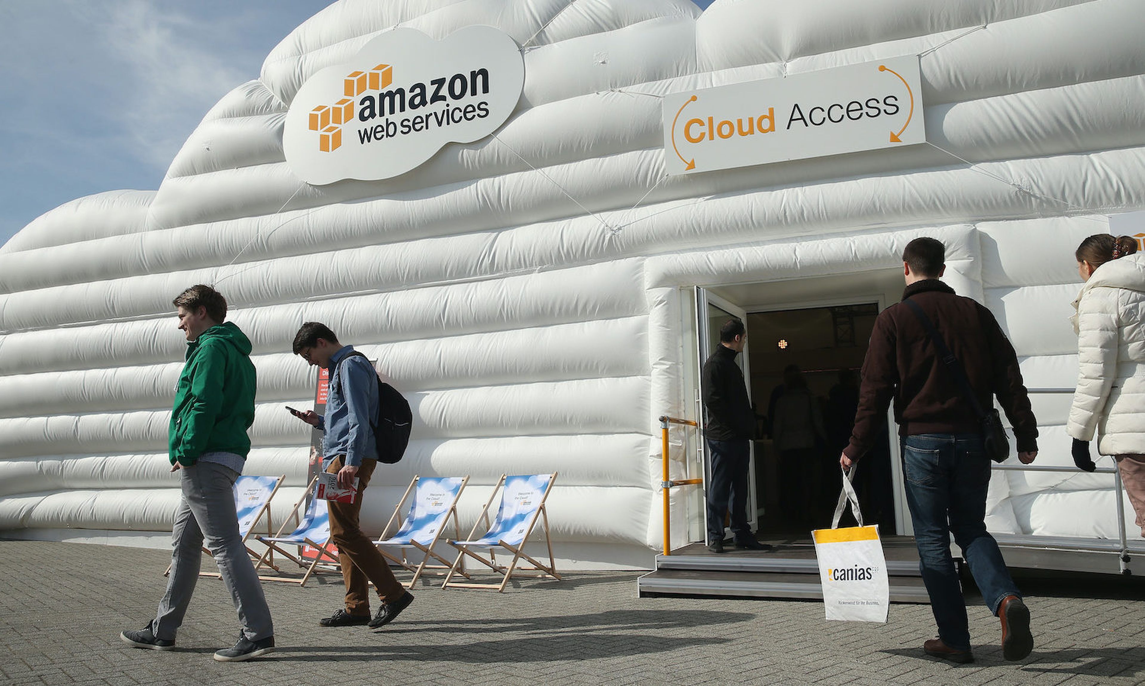 Visitors arrive at the cloud pavilion of Amazon Web Services at the 2016 CeBIT digital technology trade fair in Hanover, Germany. Researchers found a flaw in Amazon Kindle devices that give an attacker root access, steal sensitive data and turn the device into a malicious bot for future attacks. (Photo by Sean Gallup/Getty Images)