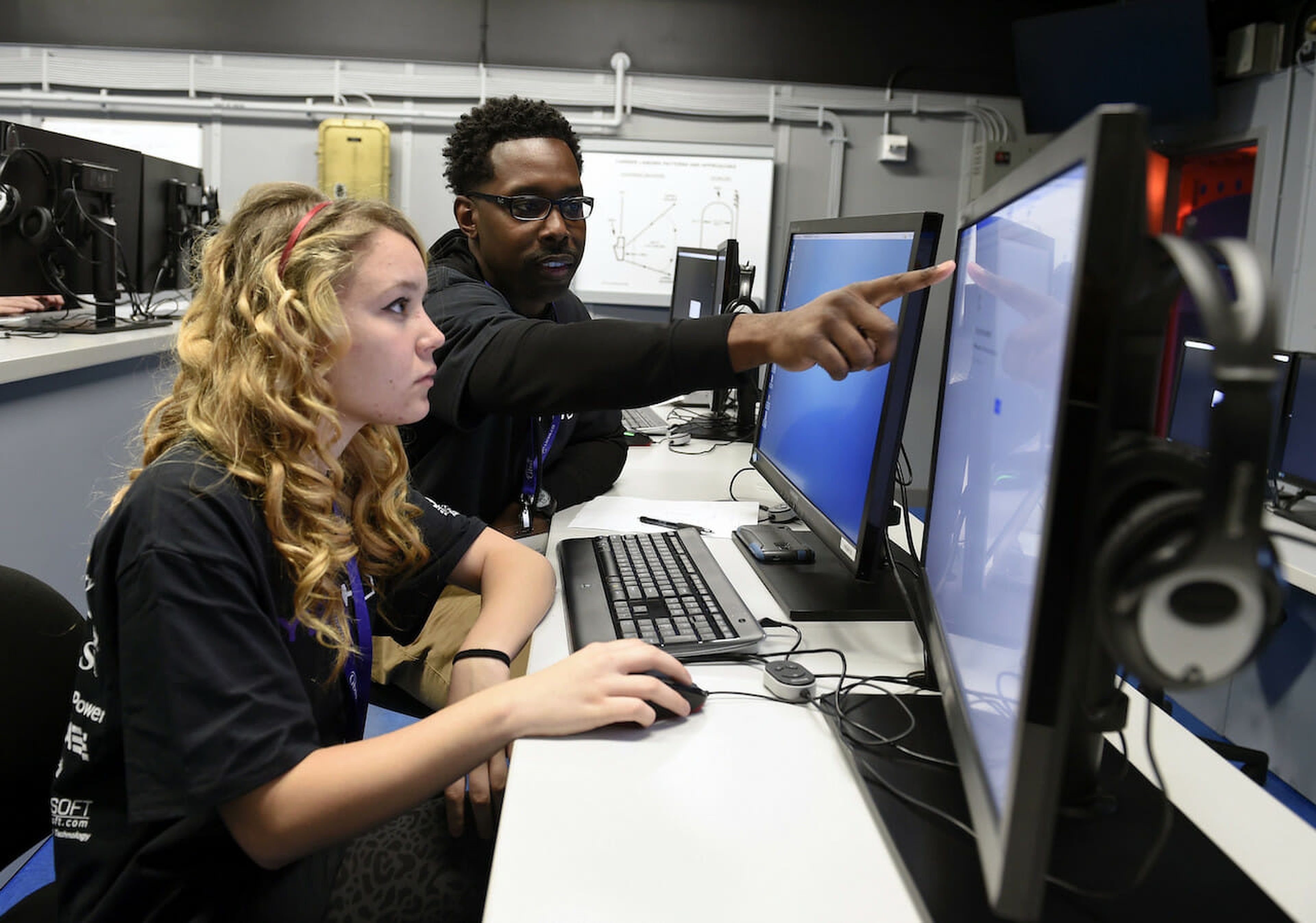 A Naval cryptologic technician works with a high school student at a Cyberthon in Pensacola, Fla. Today’s columnist, David “Moose” Wolpoff of Randori, says companies spend too much money on tools they don’t use. Better to invest in people and train them so they really know how to use the tools. (Official U.S. Navy Imagery CC BY 2.0)