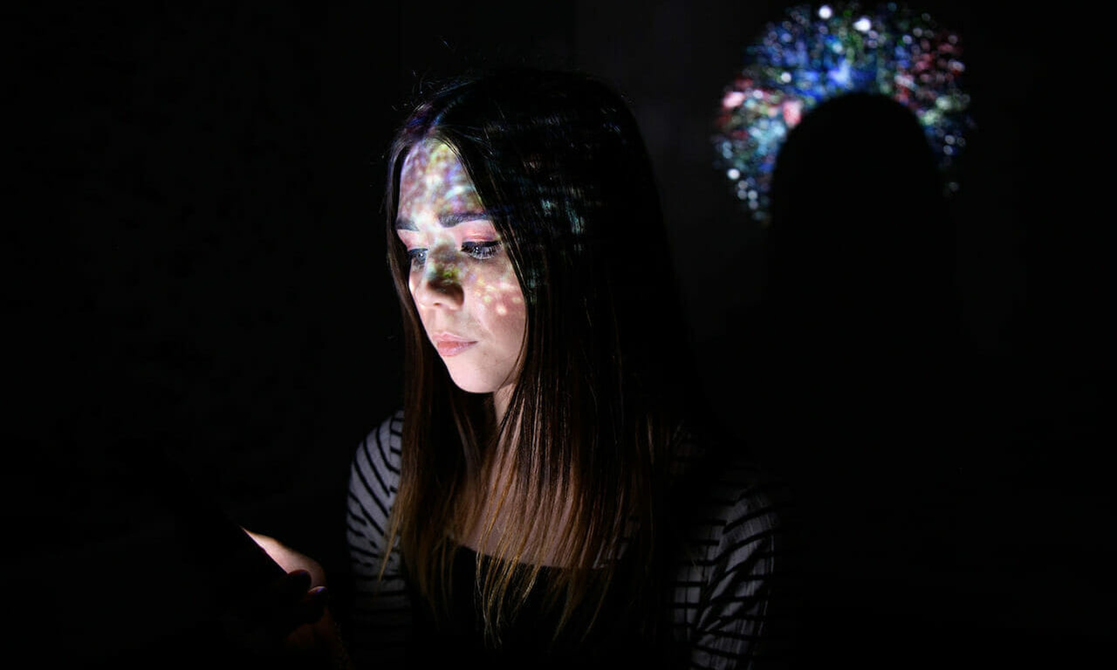 A 2020 survey of infosec professionals found that U.S.-based male respondents take home an average annual salary of $91,000, while female participants earn an average of $62,000 per year.  In this photo illustration,  a virtual map of the internet is projected onto a woman. (Leon Neal/Getty Images)