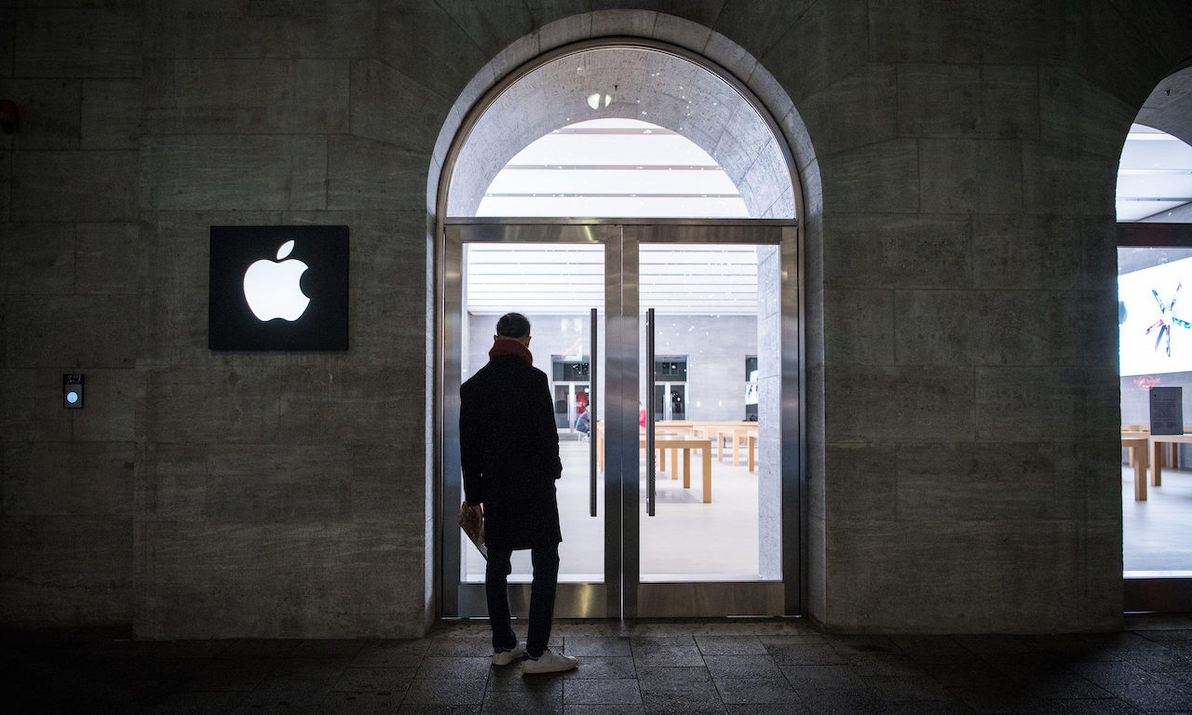 A man stands in front of Apple store in Berlin, Germany. Threat actors have abused the Run Script feature in Apple’s Xcode integrated development environment (IDE) to infect Apple developers via shared Xcode projects. (Photo by Steffi Loos/Getty Images)