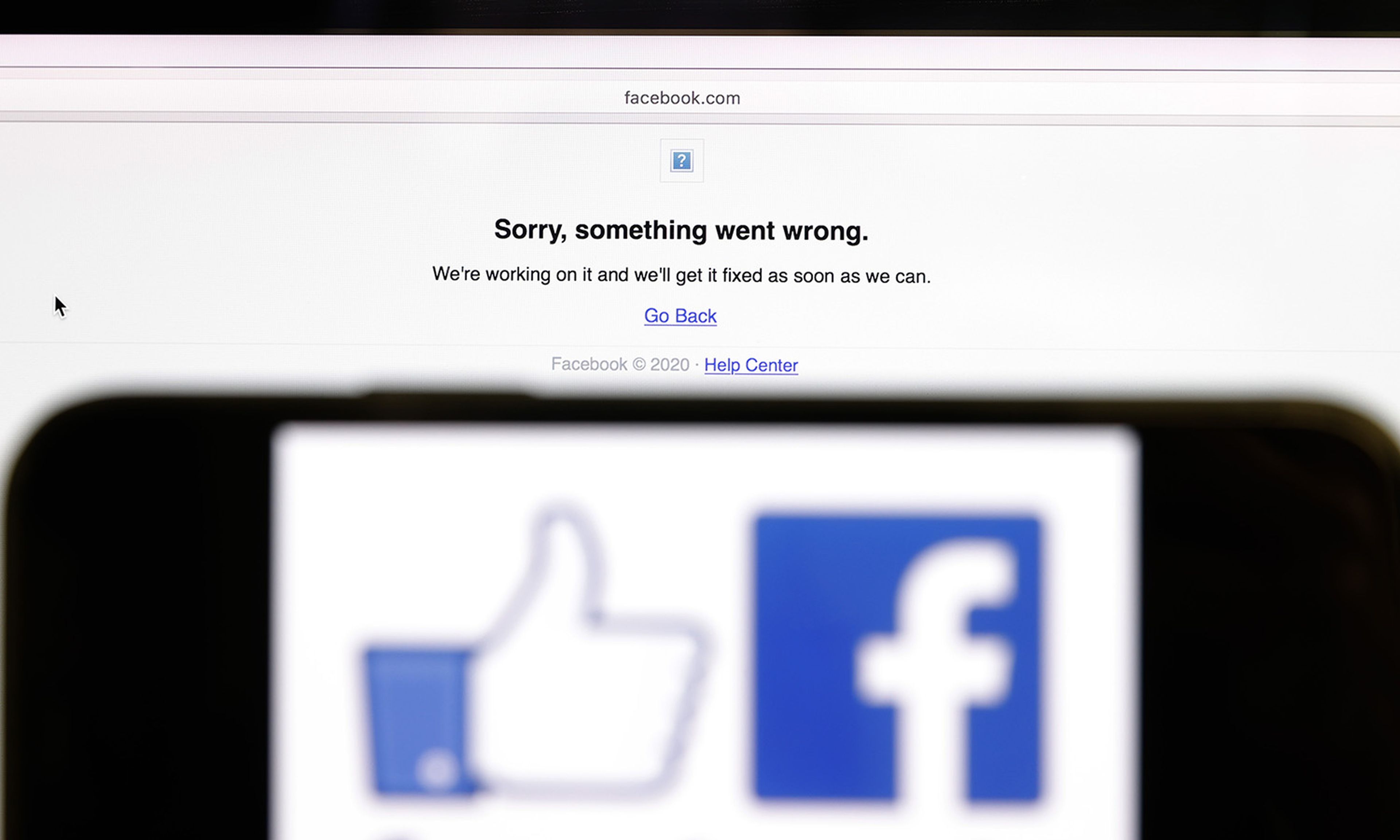 In this photo illustration, the Facebook logo is displayed next to a screen showing that Facebook service was down on Oct. 4, 2021, in San Anselmo, Calif. (Photo Illustration by Justin Sullivan/Getty Images)