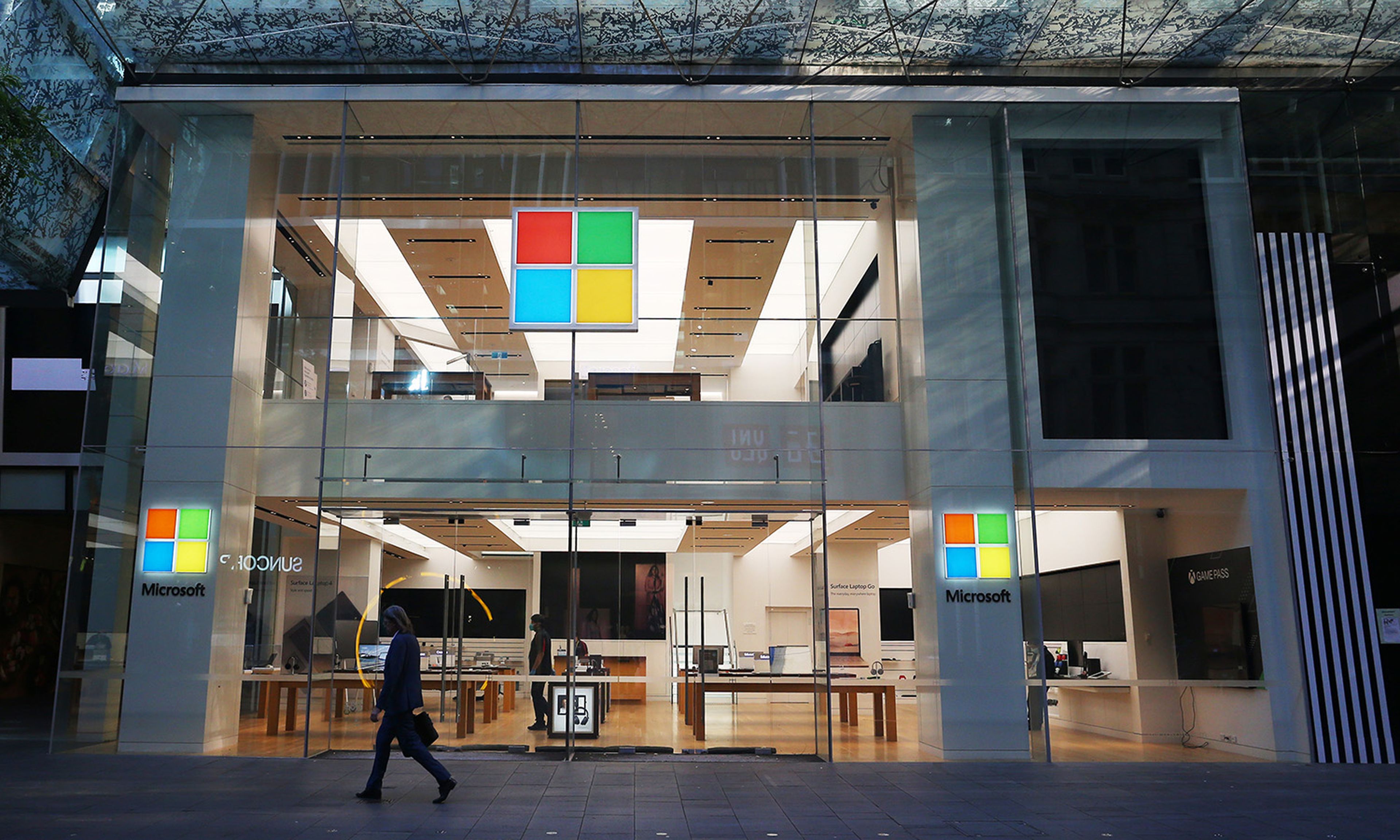 A pedestrian moves past a Microsoft store in the usually bustling Pitt Street shopping mall on Oct. 6, 2021, in Sydney, Australia. (Photo by Lisa Maree Williams/Getty Images)