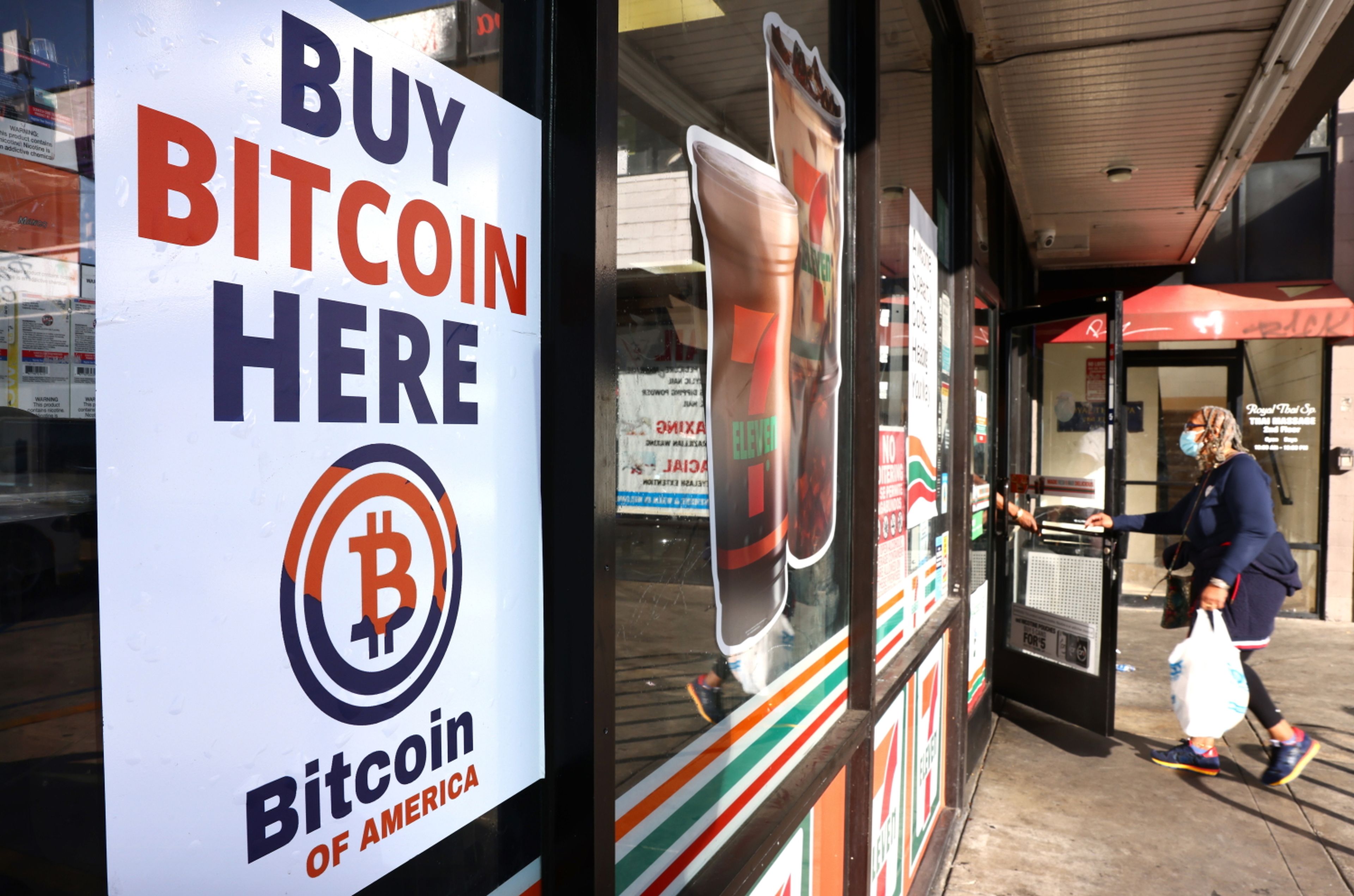 A &#8216;Buy Bitcoin Here&#8217; sign is posted at a 7-Eleven store on Nov. 10, 2021, in Los Angeles. (Photo by Mario Tama/Getty Images)