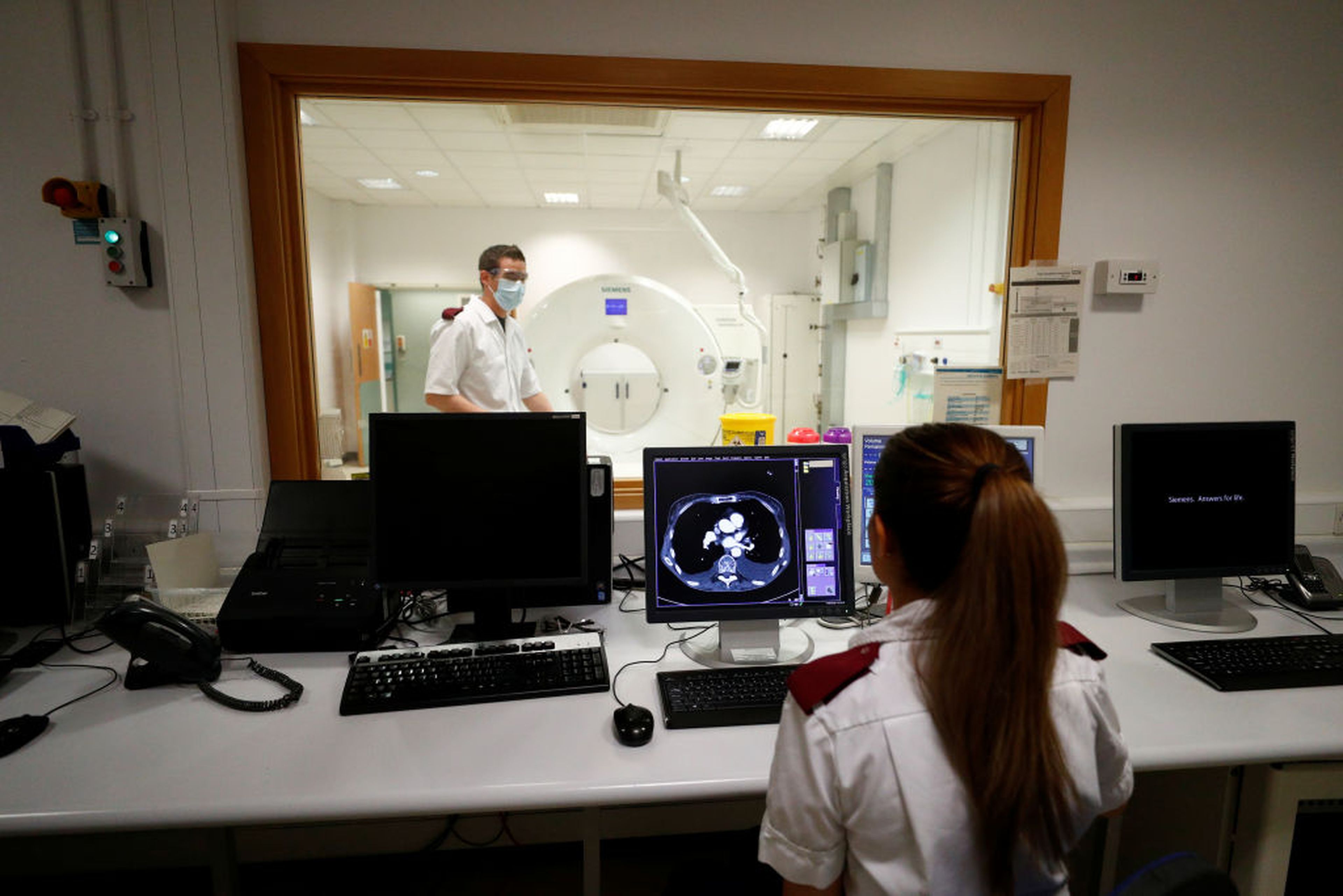 Medical staff prepare to receive a patient for a CT scan at The Royal Blackburn Teaching Hospital in East Lancashire, during the COVID-19 epidemic on May 14, 2020, in Blackburn, England. (Photo by Hannah McKay/Getty Images via Pool)