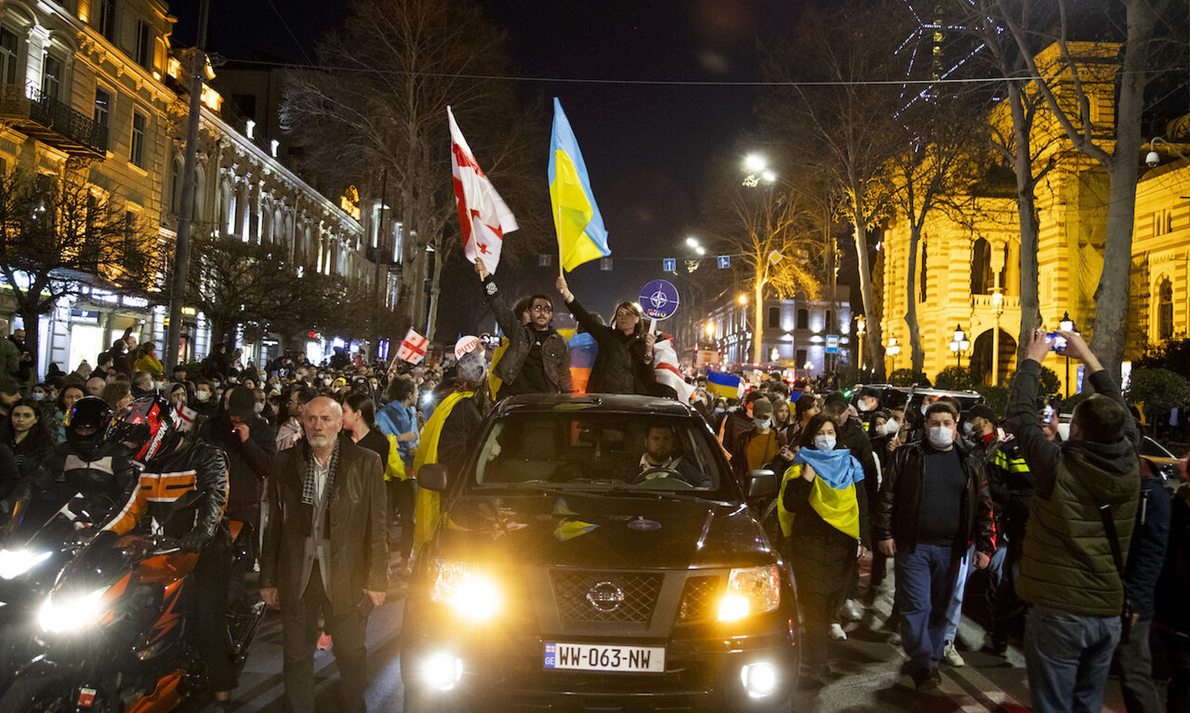 Demonstrators from cars wave flags as Georgians rally in support of Ukraine after Russia began its military invasion of the country on February 24. The other night, Russia began a large-scale attack on Ukraine, with explosions reported in multiple cities and far outside the restive eastern regions held by Russian-backed rebels. As tensions mount, t...