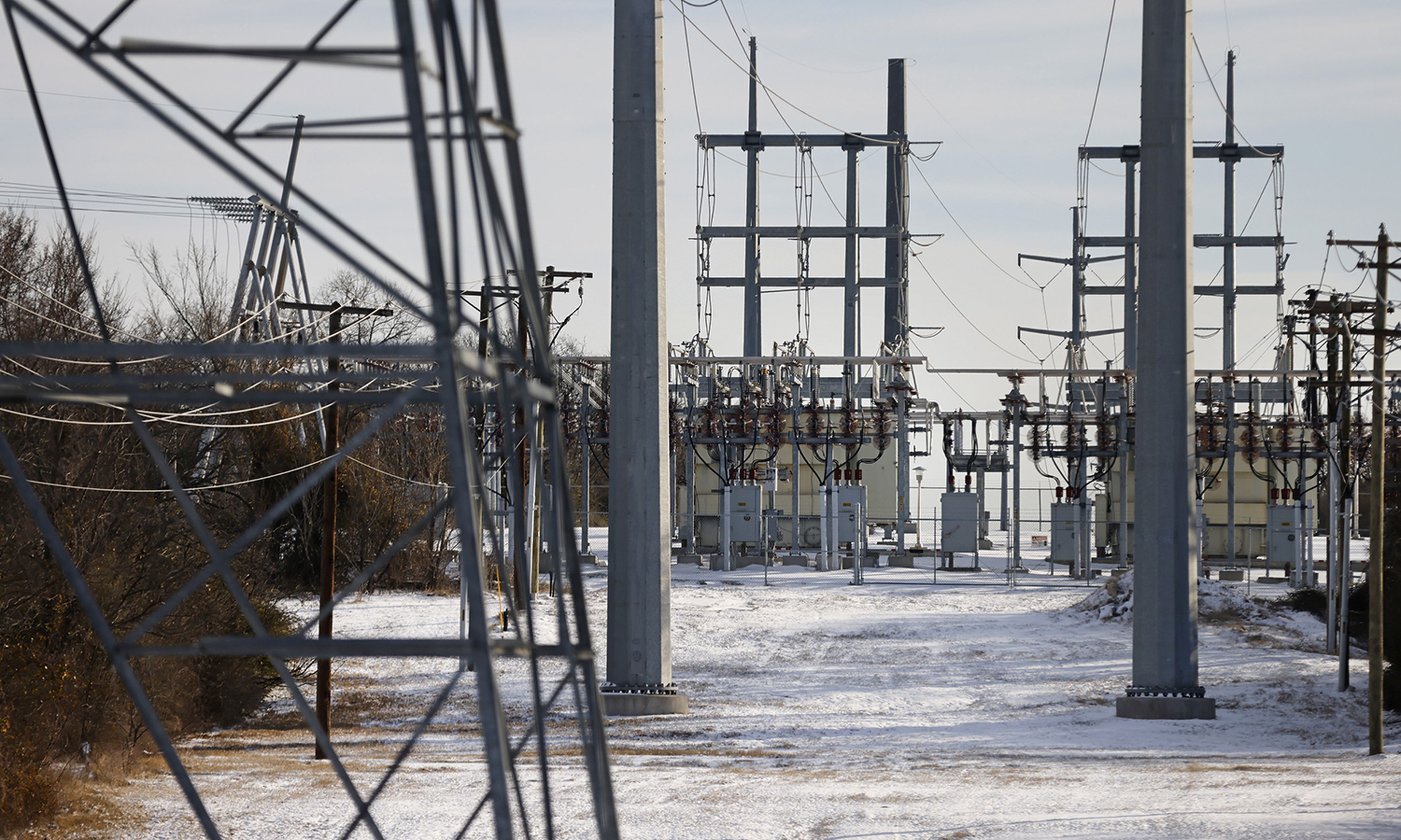Pictured: Transmission towers and power lines lead to a substation after a snow storm on Feb. 16, 2021, in Fort Worth, Texas. (Photo by Ron Jenkins/Getty Images)