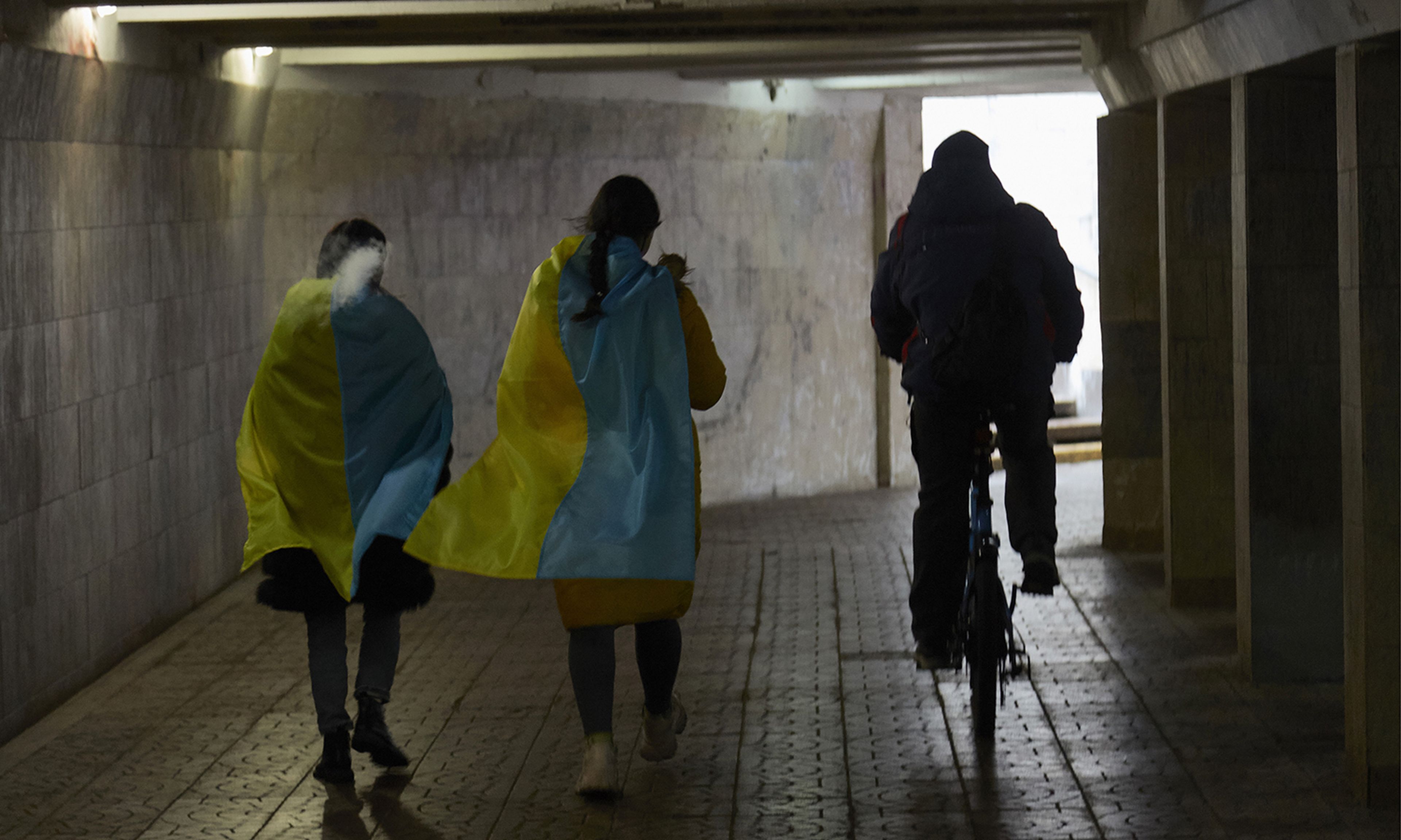 New malware targeting Ukrainian organizations, dubbed HermeticWiper, appears to obliterate a system, according to SentinelLabs. Pictured: Local residents wearing Ukrainian flags walk through an underpass on Feb. 24, 2022, in Kyiv, Ukraine. (Photo by Pierre Crom/Getty Images)