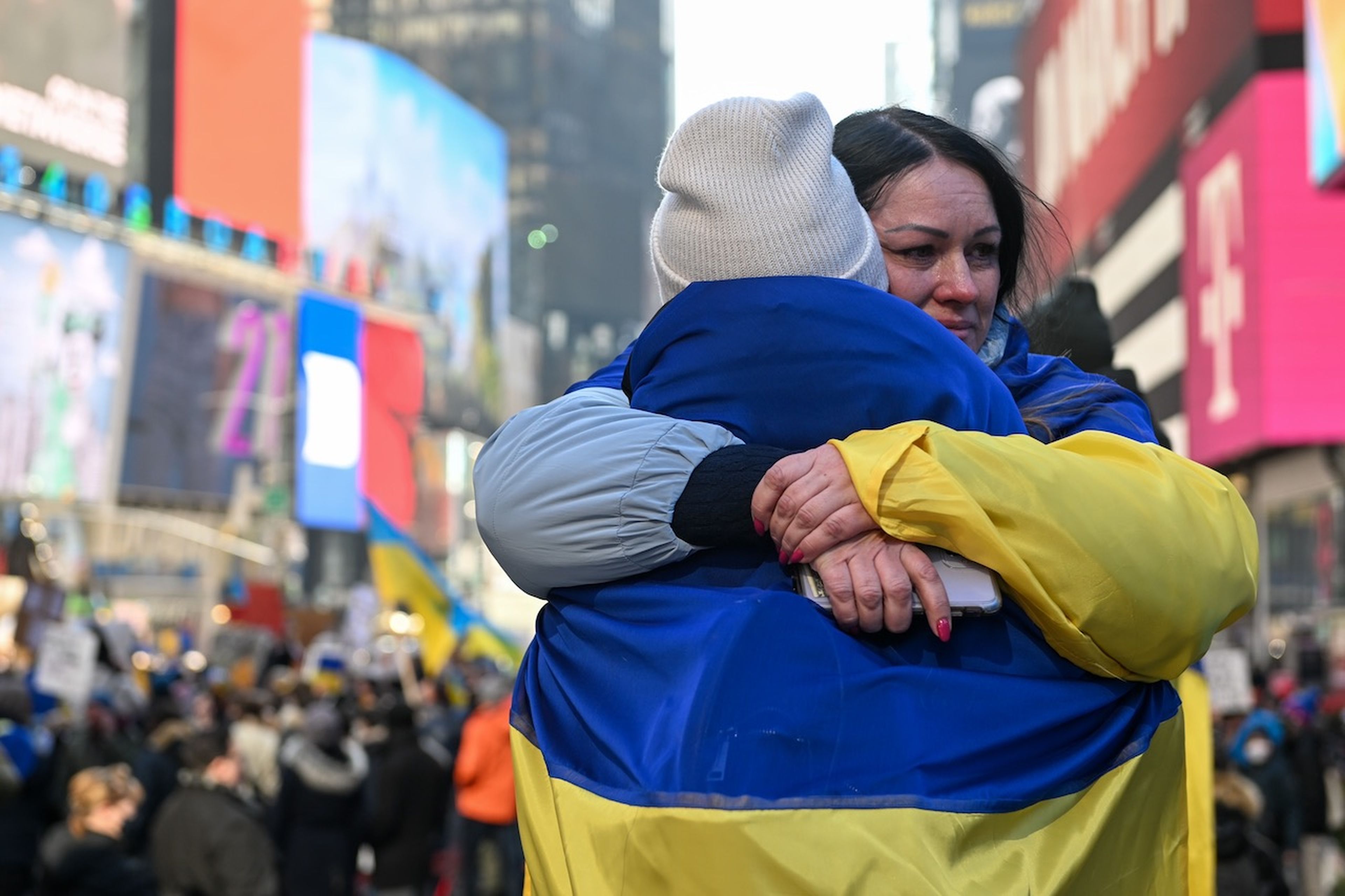 Two people draped in Ukrainian flags embrace at a &#8220;Stand With Ukraine&#8221; rally in Times Square on Feb. 26, 2022, in New York City. Cybersecurity vendors are rallying to provide free products and services to support Ukraine amid the Russian invasion. (Photo by Alexi Rosenfeld/Getty Images)
