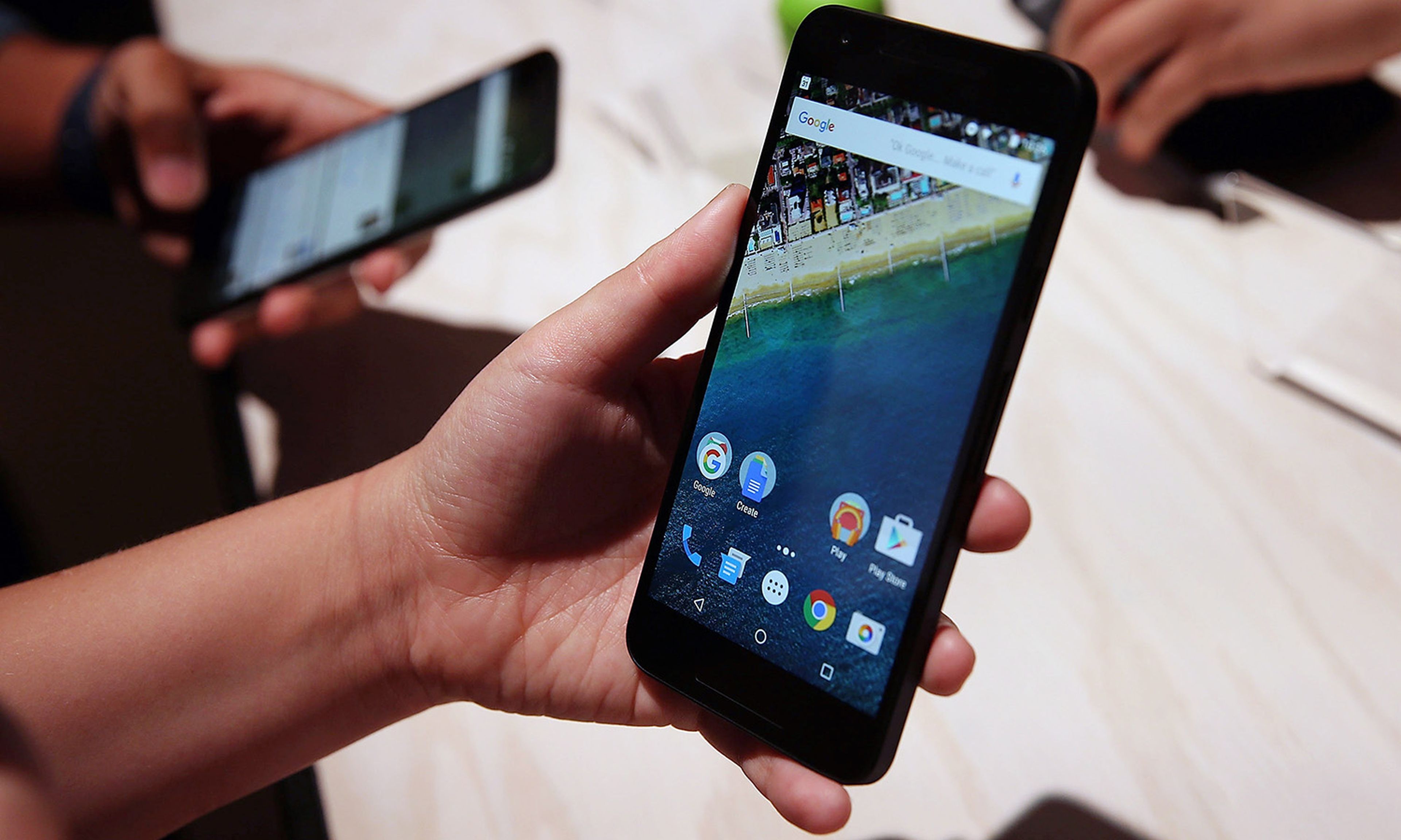 An attendee inspects a Nexus 5X phone during a Google media event on Sept. 29, 2015, in San Francisco. (Photo by Justin Sullivan/Getty Images)