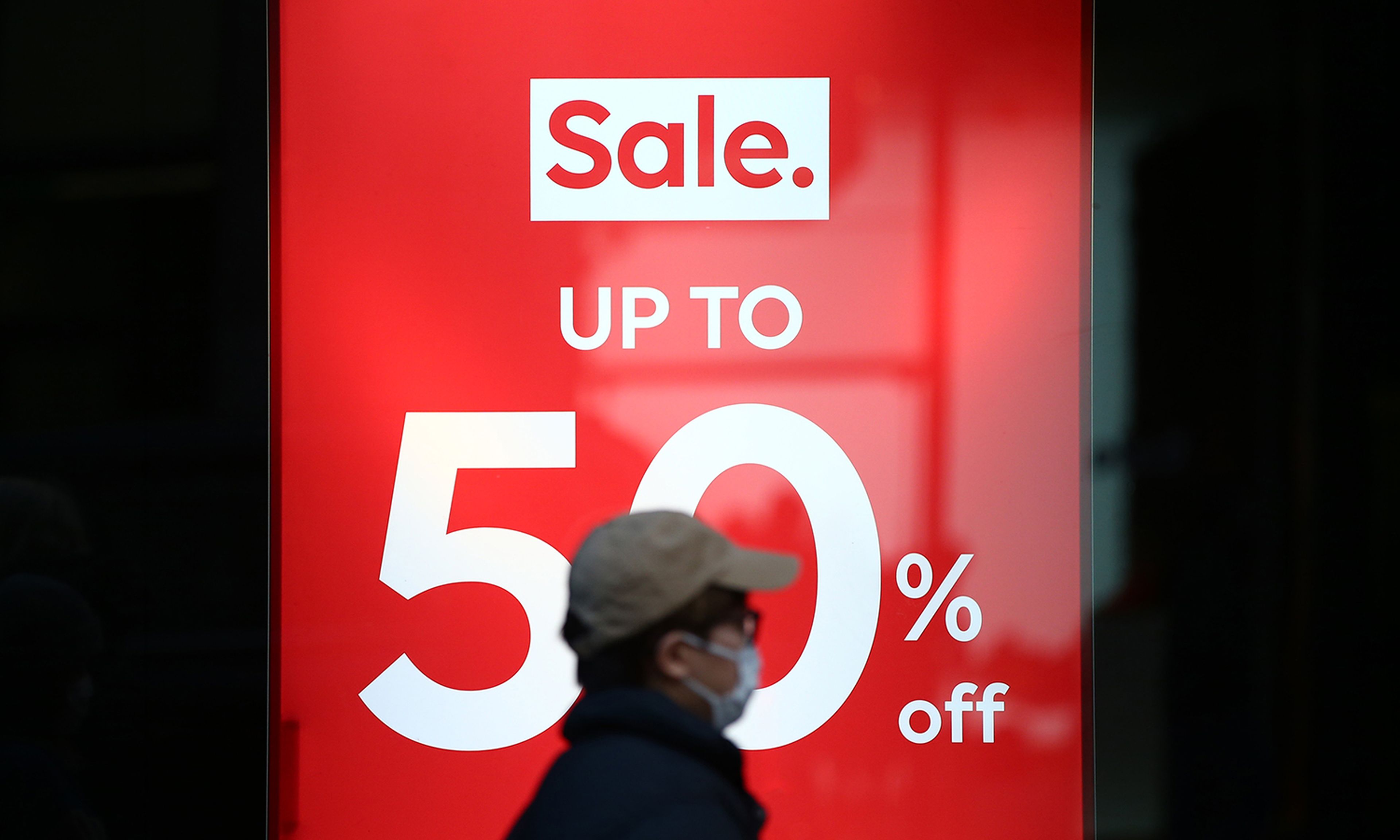 Industry experts warn the &#8220;buy now, pay later&#8221; plans may present a new attack vector for cybercriminals. Pictured: A shopper walks past a sale sign on Regent Street on Dec. 27, 2021, in London. (Photo by Hollie Adams/Getty Images)