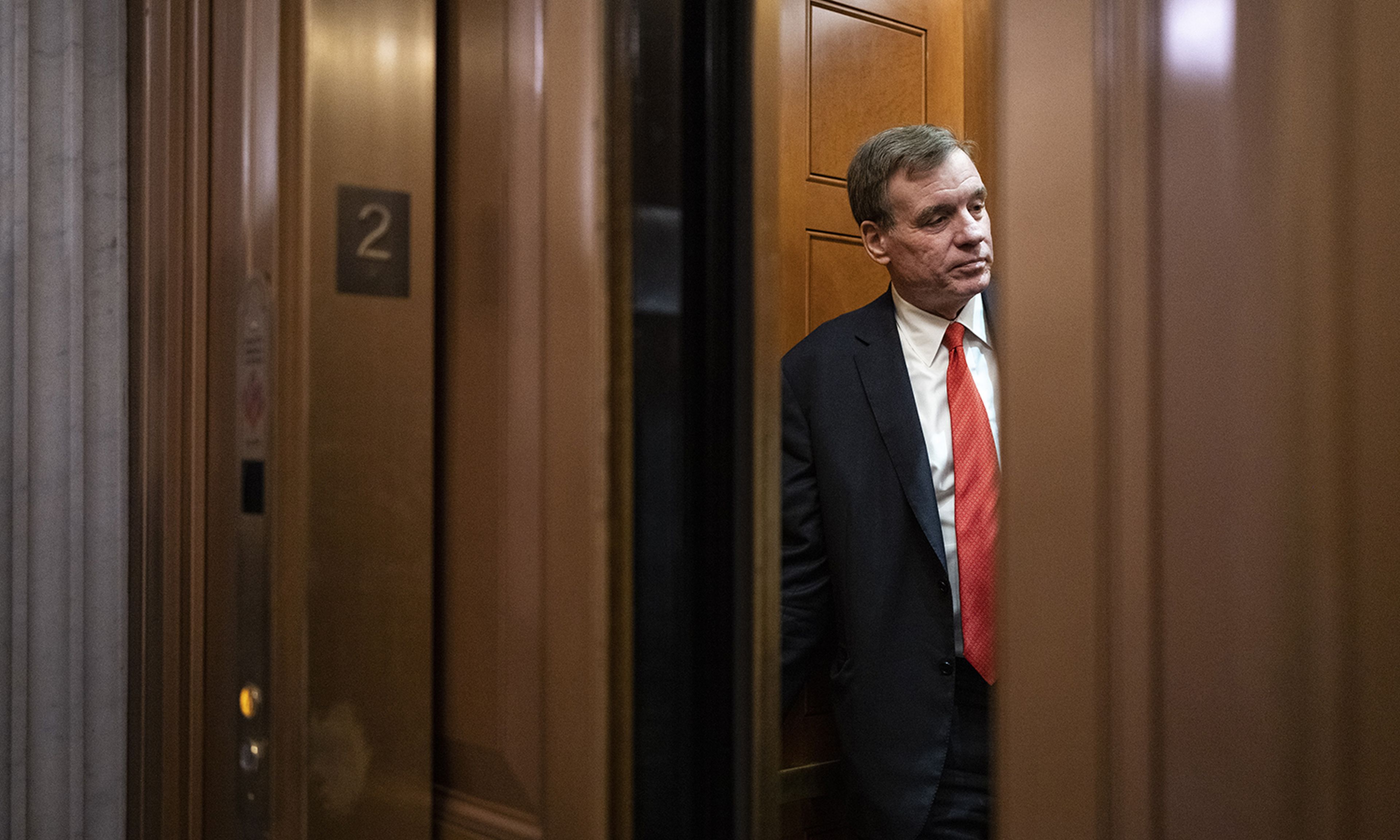 Sen. Mark Warner, D-Va., gets into an elevator outside the Senate Chamber at the U.S. Capitol on April 7, 2022, in Washington. (Photo by Drew Angerer/Getty Images)