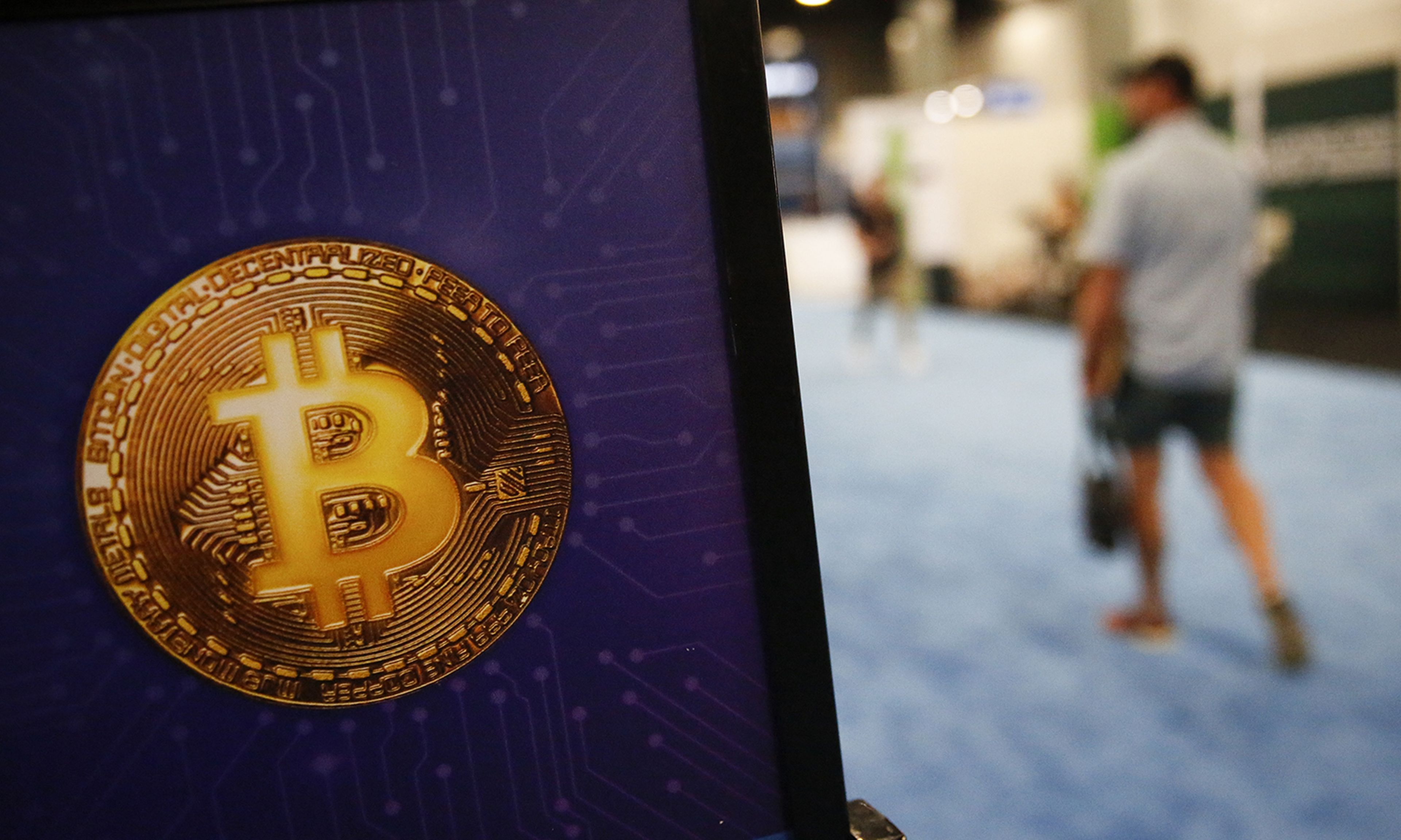 A Bitcoin logo is seen during the Bitcoin 2022 Conference at Miami Beach Convention Center on April 8, 2022, in Miami. (Photo by Marco Bello/Getty Images)