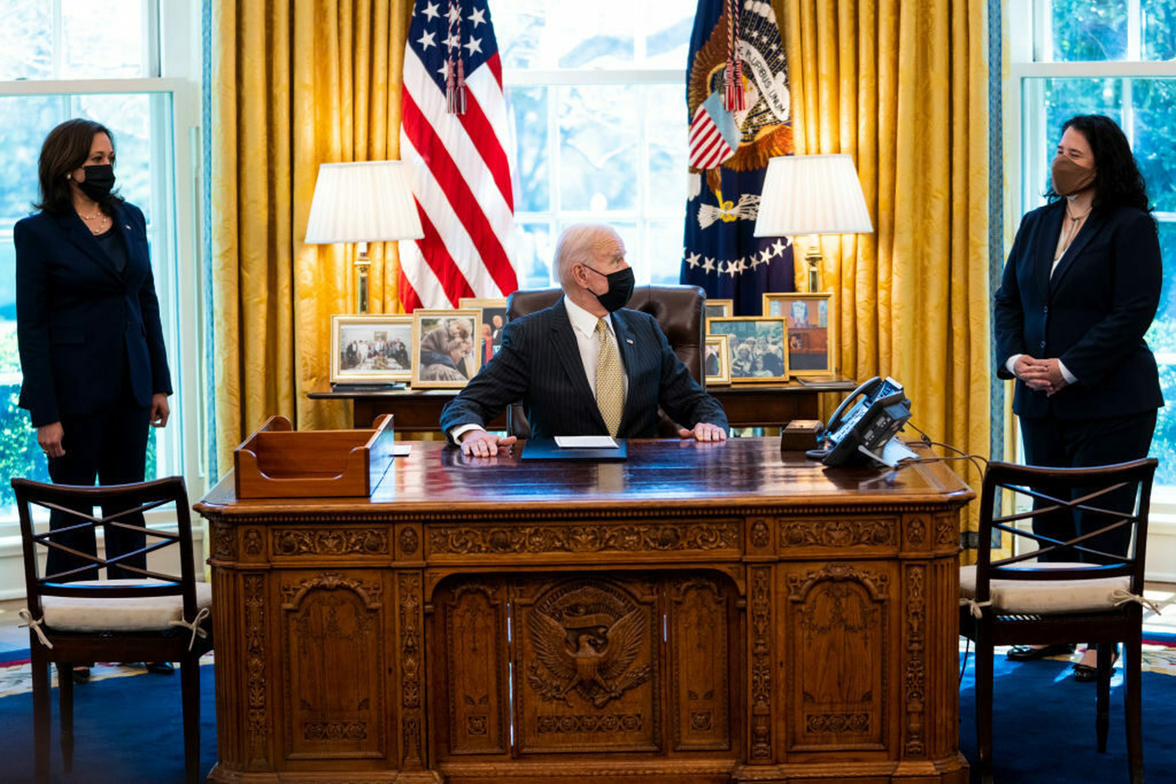 Flanked by Vice President Kamala Harris, left, and Administrator of the Small Business Administration (SBA) Isabella Casillas Guzman, right, President Joe Biden signs the Paycheck Protection Program (PPP) extension in the Oval Office on March 30, 2021, in Washington. A cybersecurity audit of the Small Business Administration found that pandemic rel...