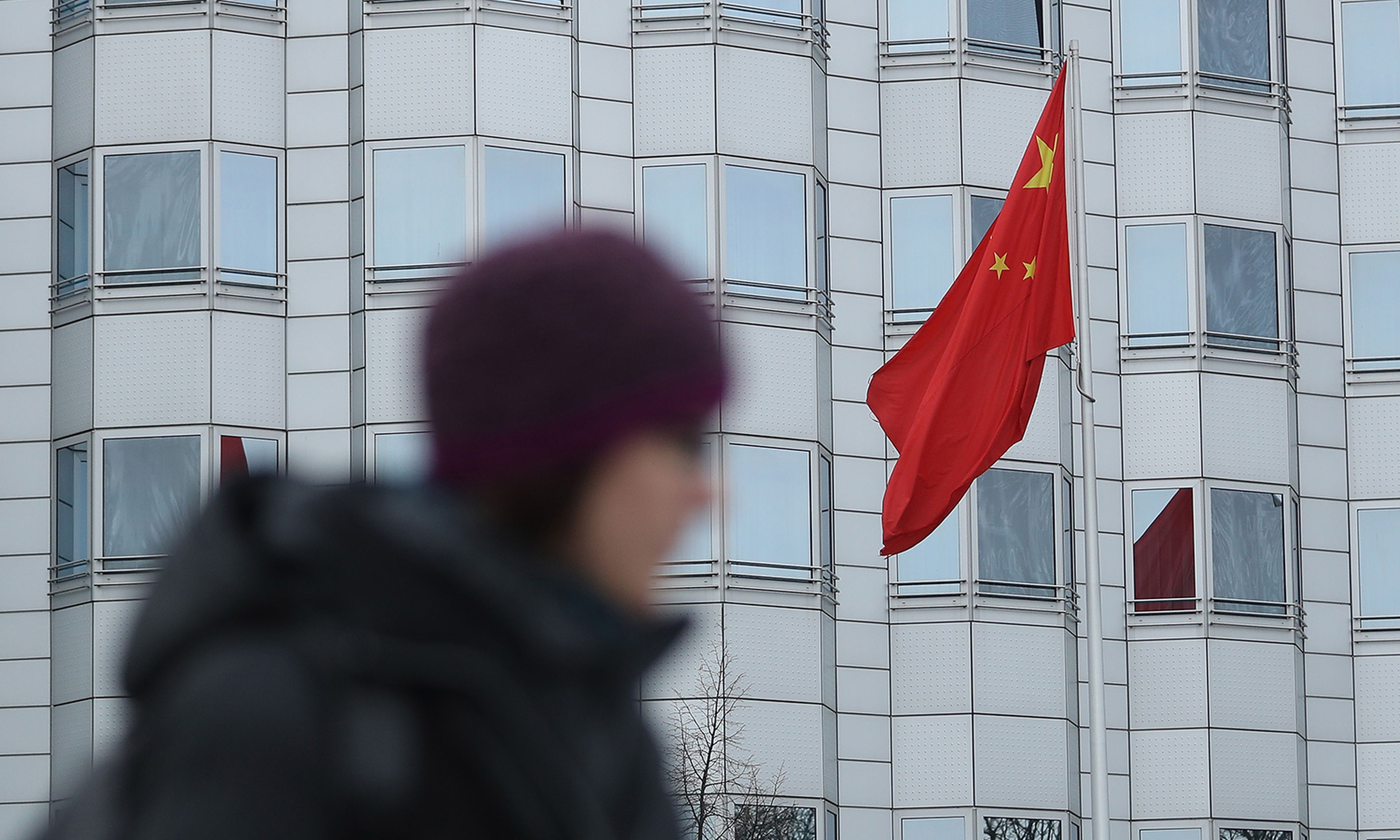A woman walks past the Chinese Embassy on Dec. 11, 2017, in Berlin. (Photo by Sean Gallup/Getty Images)