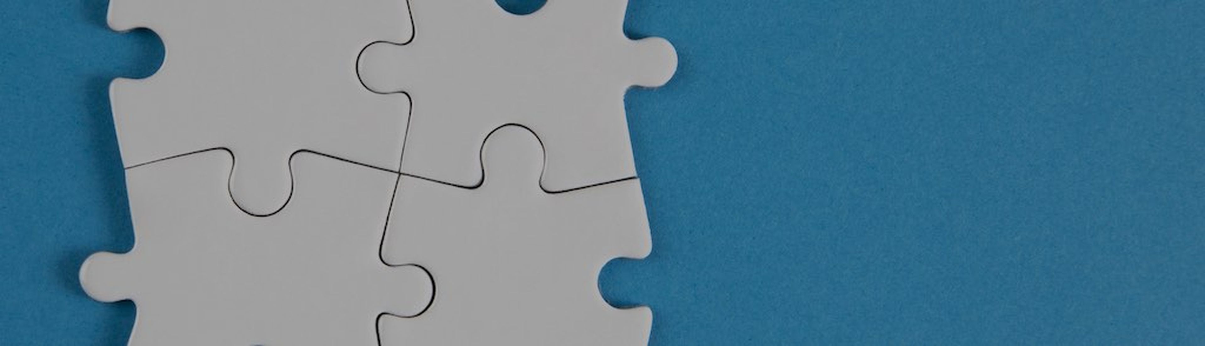 Jigsaw puzzle pieces on blue background