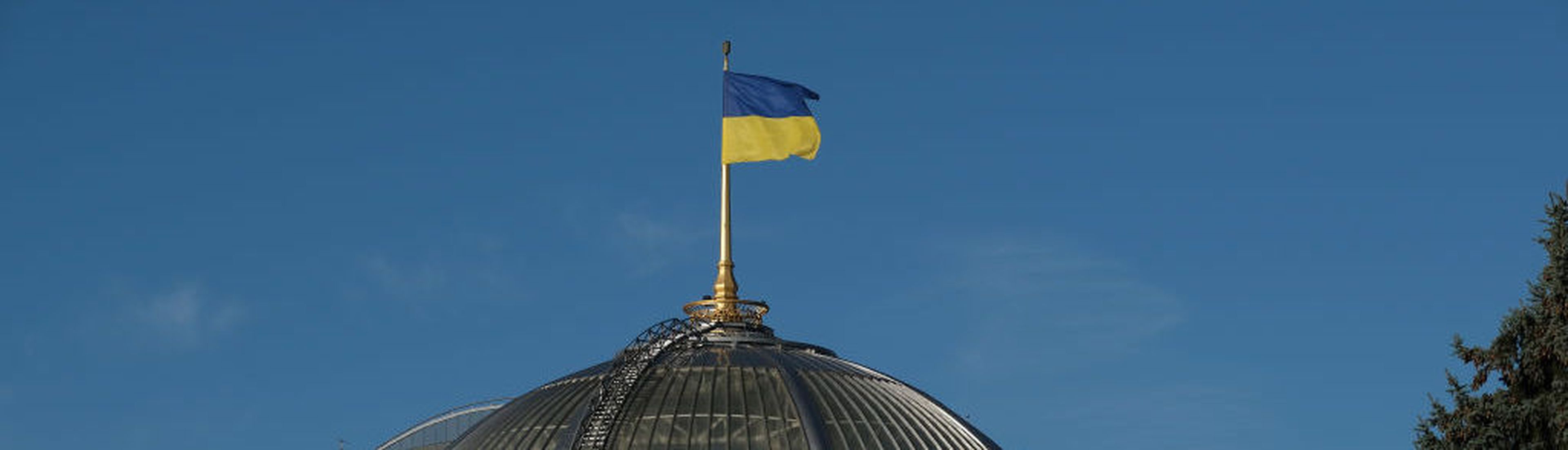 KIEV, UKRAINE &#8211; OCTOBER 02: The Ukrainian flag flies over the Verchovna Rada, the Ukrainian Parliament, on October 02, 2019 in Kiev, Ukraine. Ukraine has found itself at the core of a political storm in U.S. politics since the release of a whistleblower&#8217;s complaint suggesting U.S. President Donald Trump, at the expense of U.S. foreign p...