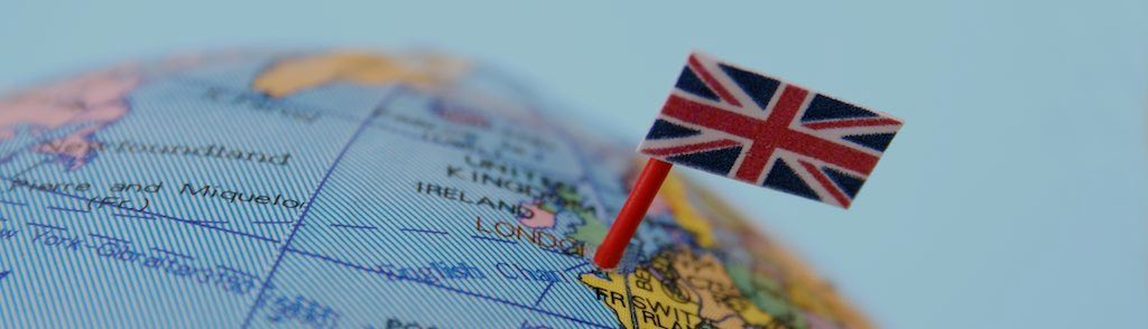 United Kingdom flag pointing London in cheap plastic globe. Shallow depth of field