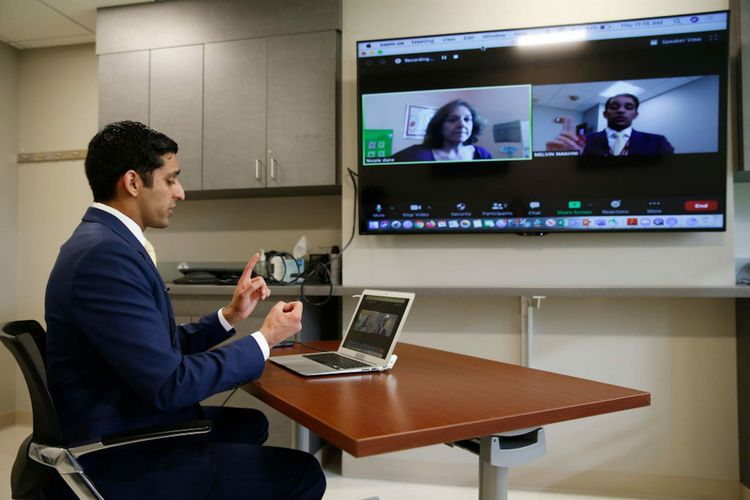 A spine surgeon at Brigham and Women&#8217;s Hospital in Boston demonstrates a telehealth follow-up appointment with a recent surgery patient. (Photo by Jessica Rinaldi/The Boston Globe via Getty Images)