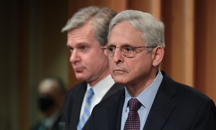U.S. Attorney General Merrick Garland, right, and FBI Director Christopher Wray hold a press conference on the REvil ransomware attacks. (Photo by Chip Somodevilla/Getty Images)
