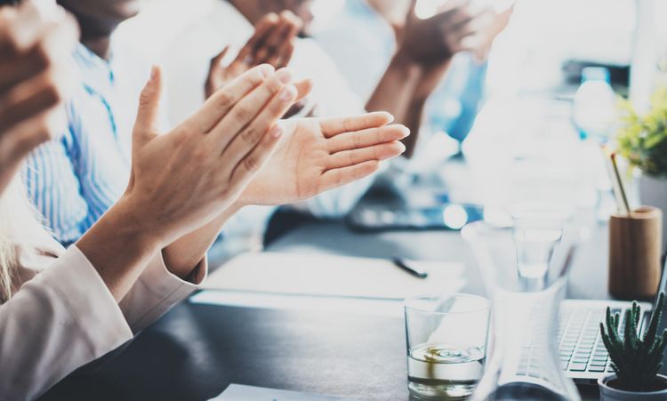 Closeup photo of partners clapping hands after business seminar. Professional education, work meeting, presentation or coaching concept.Horizontal,blurred background