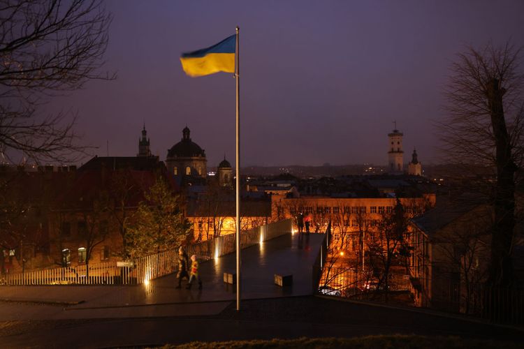 LVIV, UKRAINE &#8211; FEBRUARY 25: A Ukrainian flag flies over an observation platform in the city center on February 25, 2023 in Lviv, Ukraine. While Lviv, located in western Ukraine, lies far from the current fighting raging between Ukrainian and Russian armed forces in the east and even offers a sense of normalcy in every day life, it neverthele...