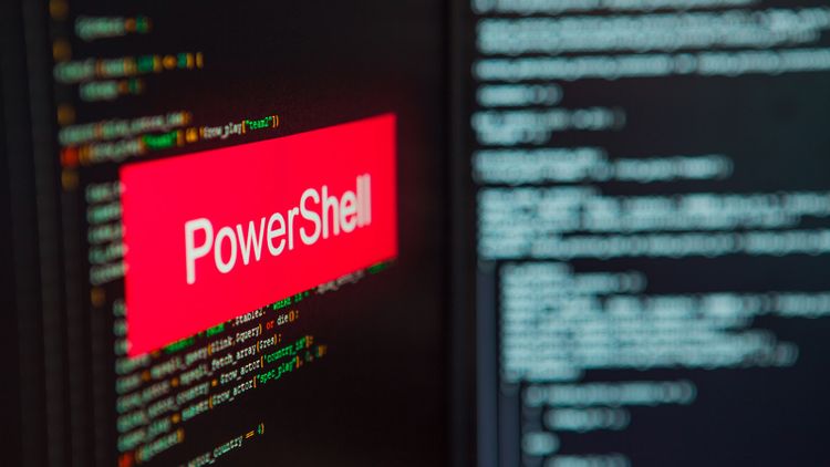 PowerShell inscription on the background of computer code.