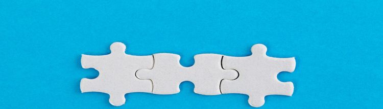 Three white jigsaw pieces on blue background.